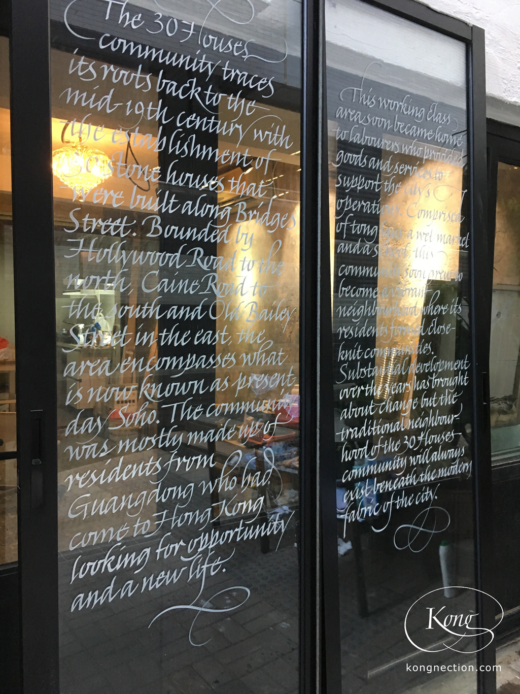 Writing the story of the '30 Houses Community' on glass doors for Chez Trente.