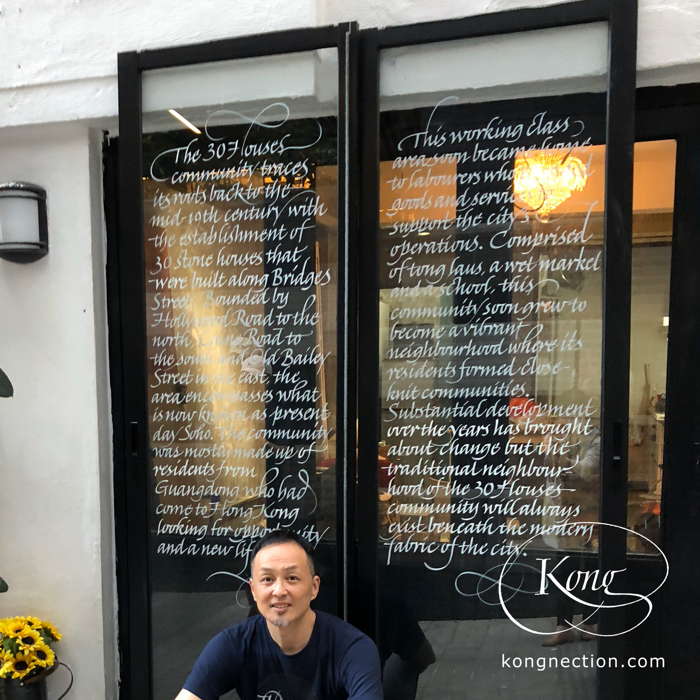 Writing the story of the '30 Houses Community' on glass doors for Chez Trente.
