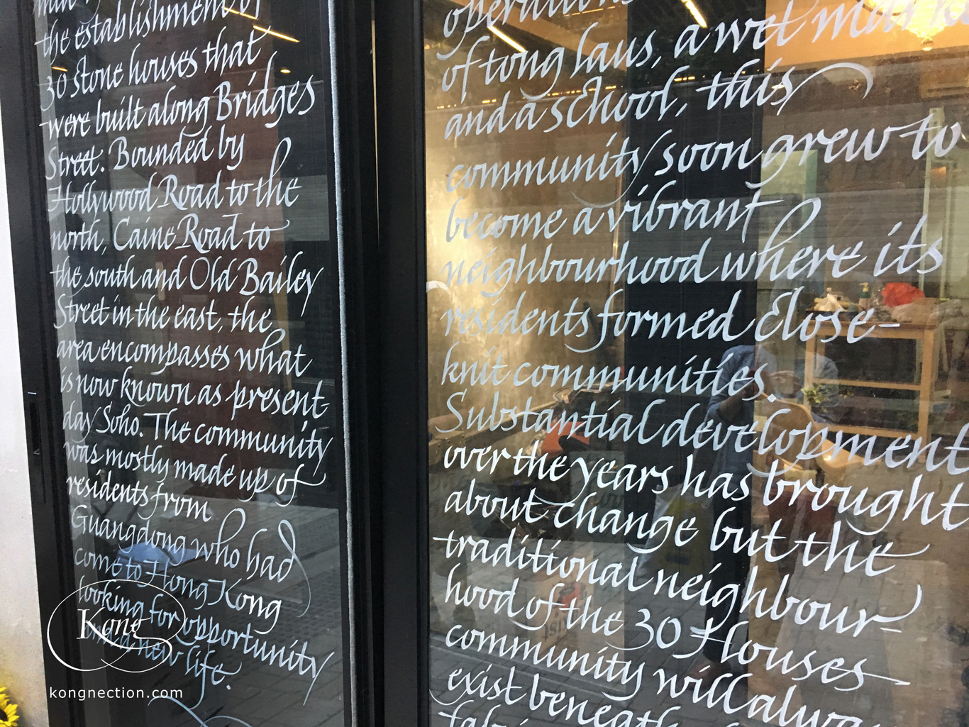 Writing the story of the '30 Houses Community' on glass doors for Chez Trente.