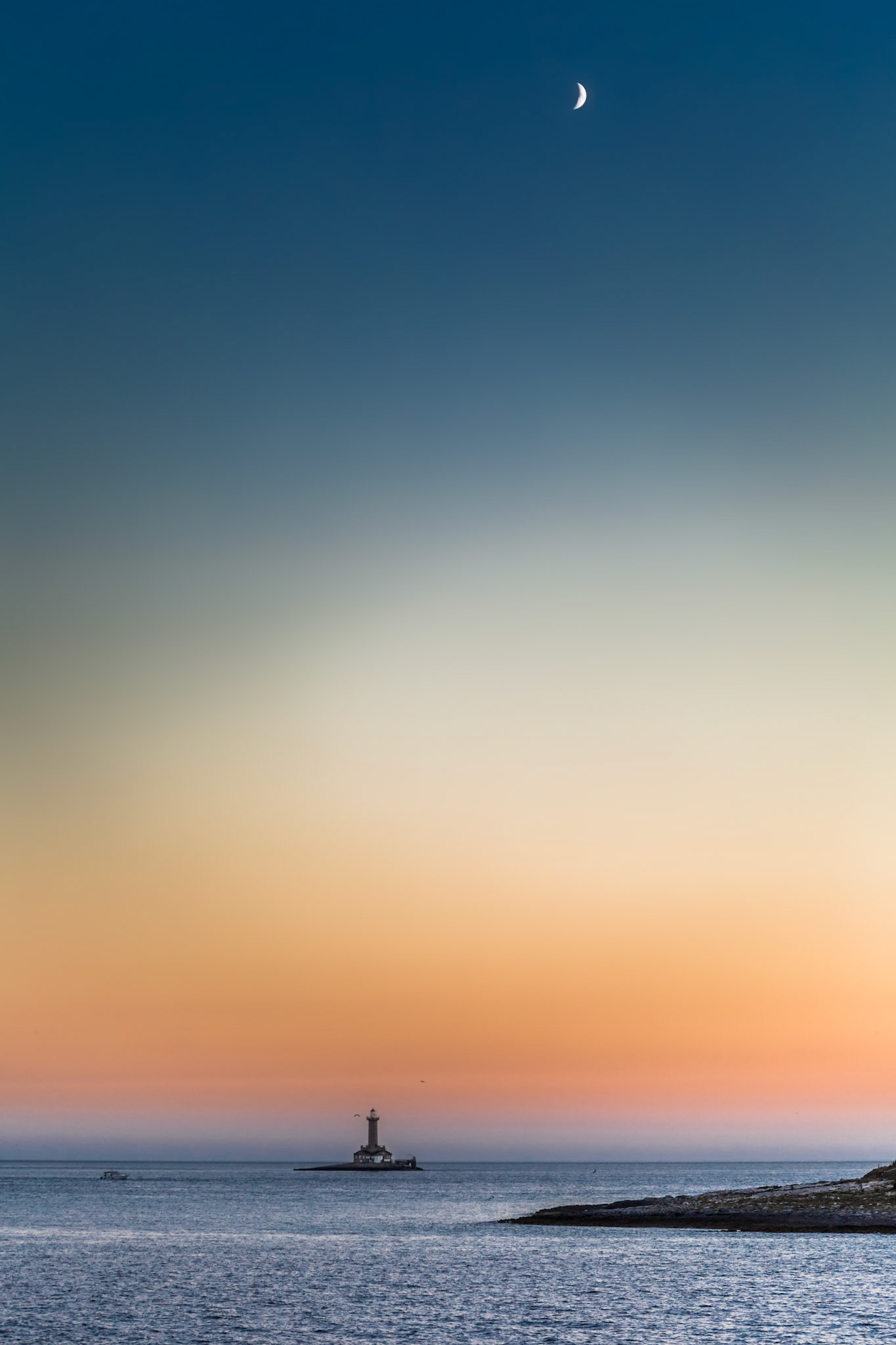 Mystical lighthouse and the young moon