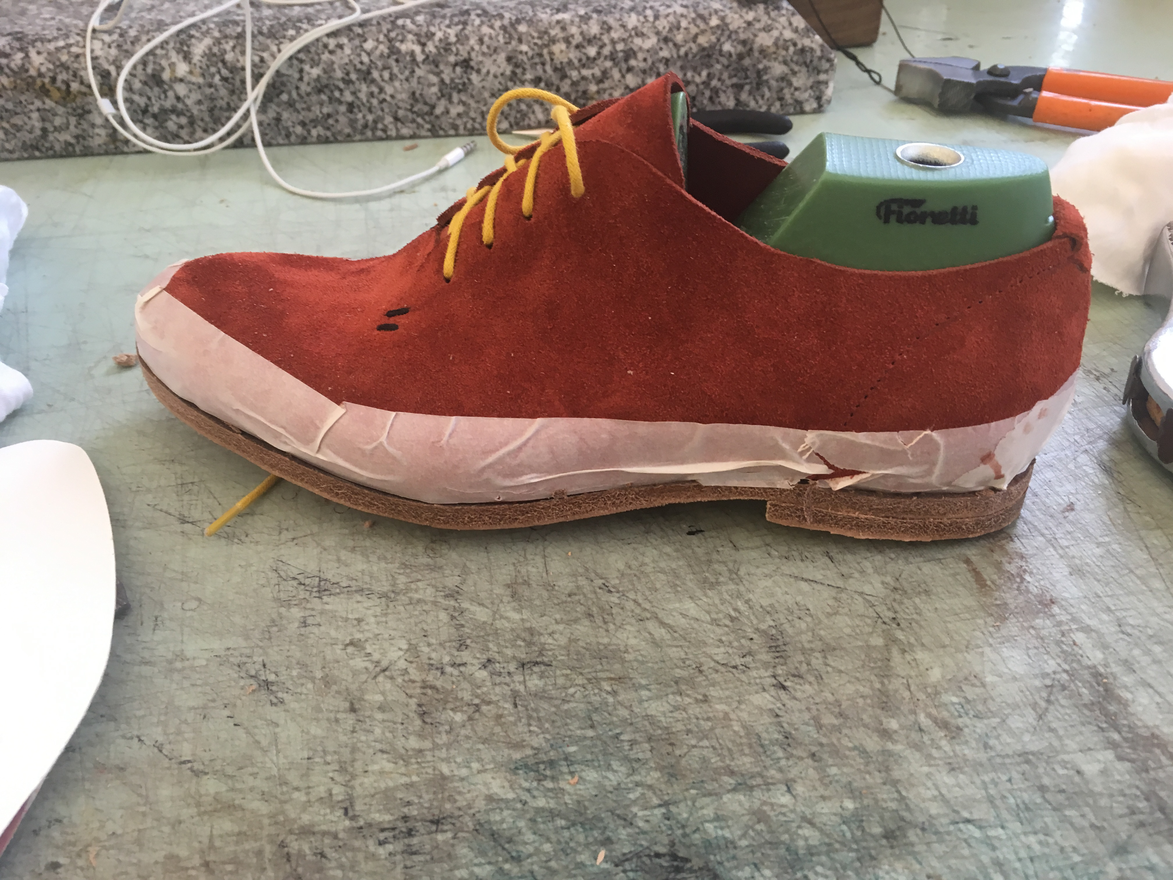 Leather sole excess trimmed + 1st step of heel