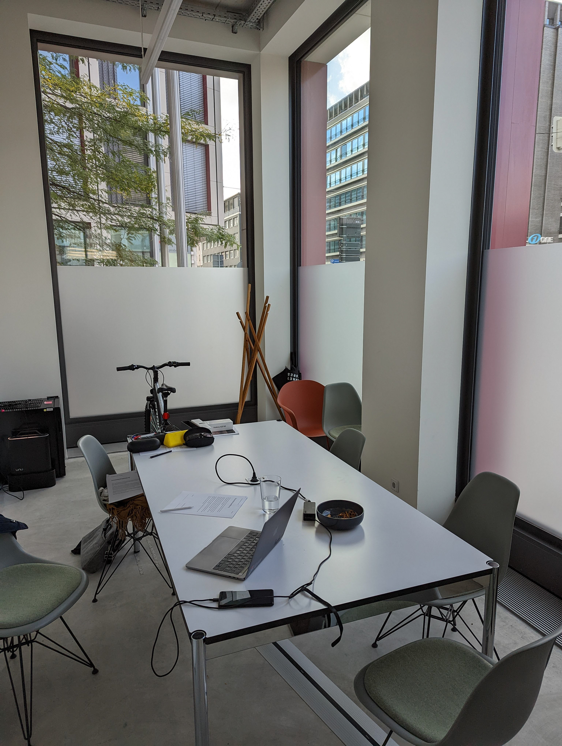 The user testing environment. A small room with a bicycle and a table. The table has various devices and paperwork scattered across it.