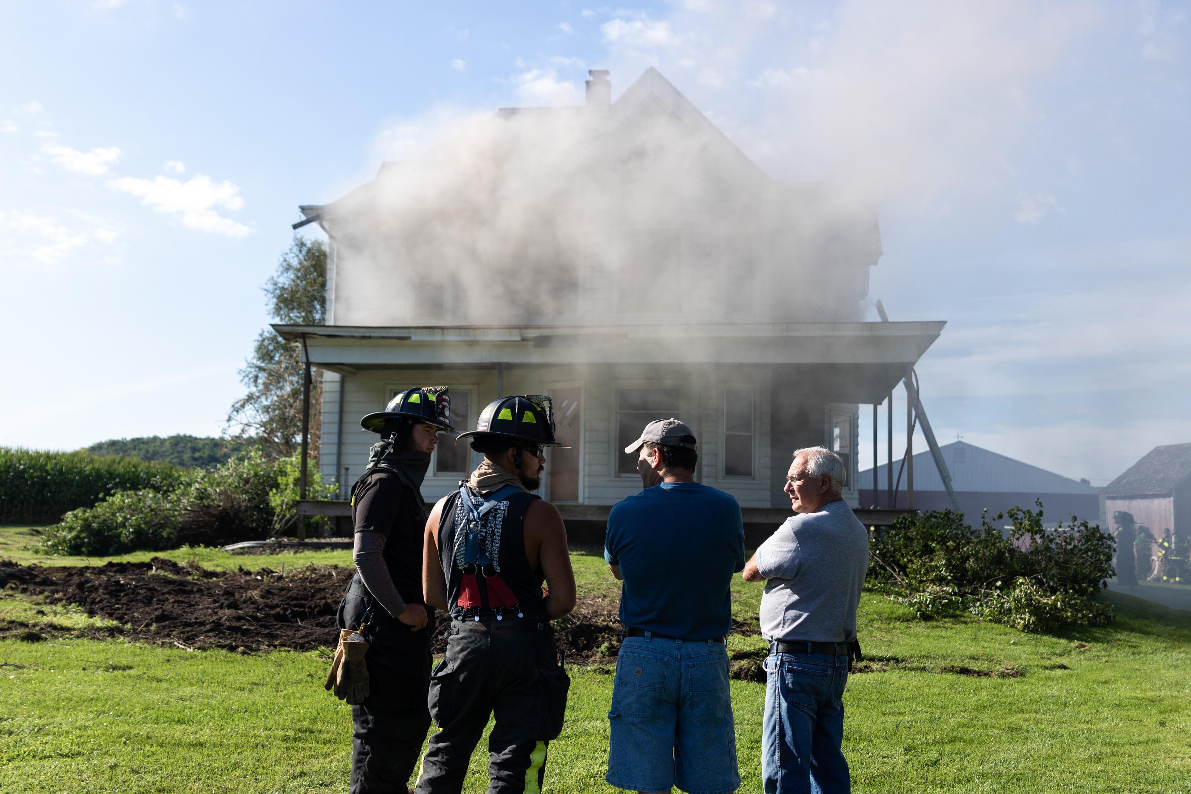Ron Marx (far right) and his son chat with two Arena firefighters.