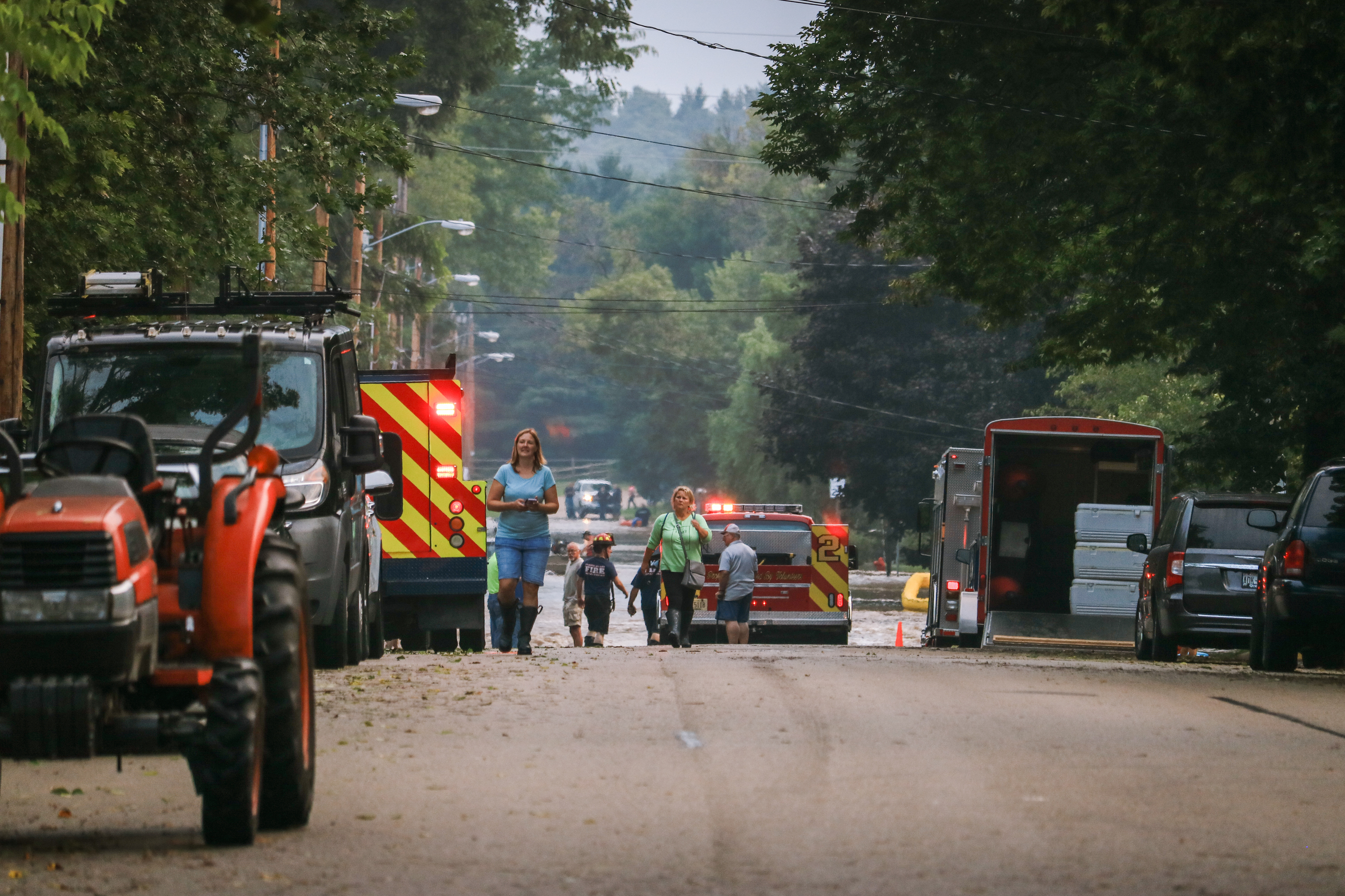 Multiple rescue vehicles use Bridge Street as a launch point for boats.