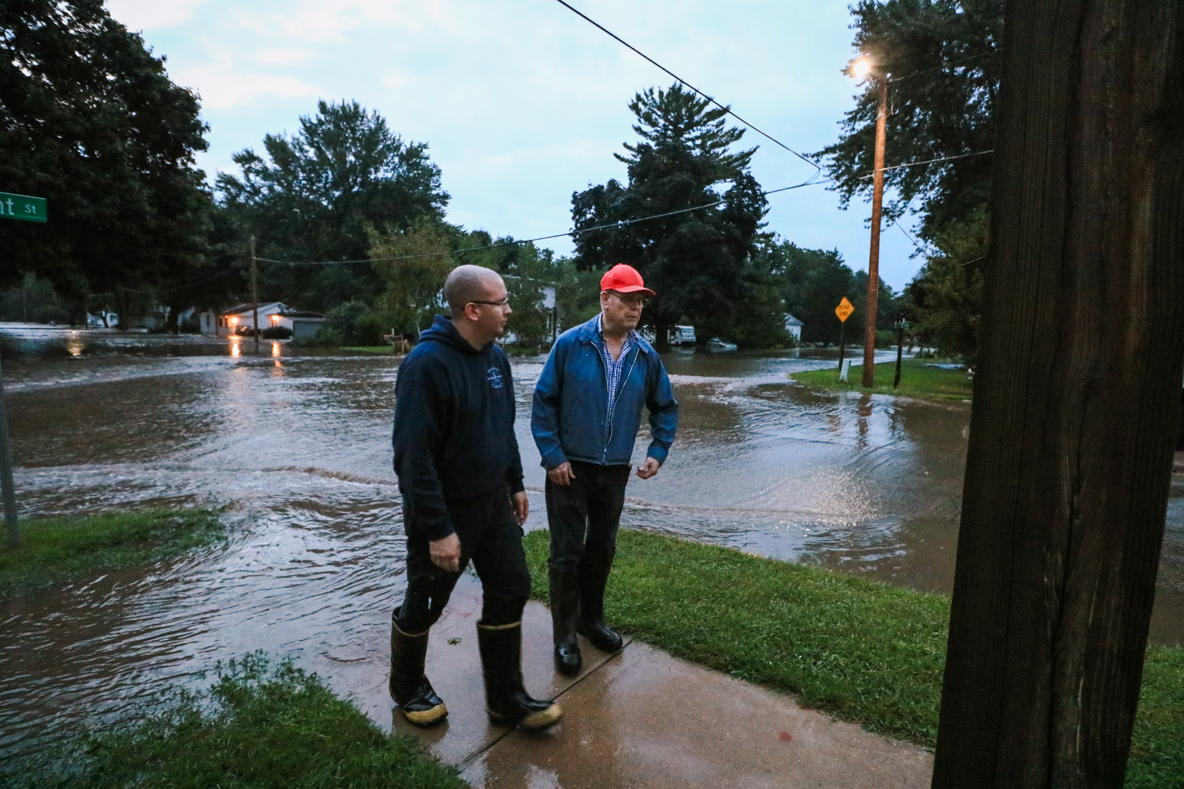 Mike Travis and Bob Dublin stand inches from the flood water from August 21st.