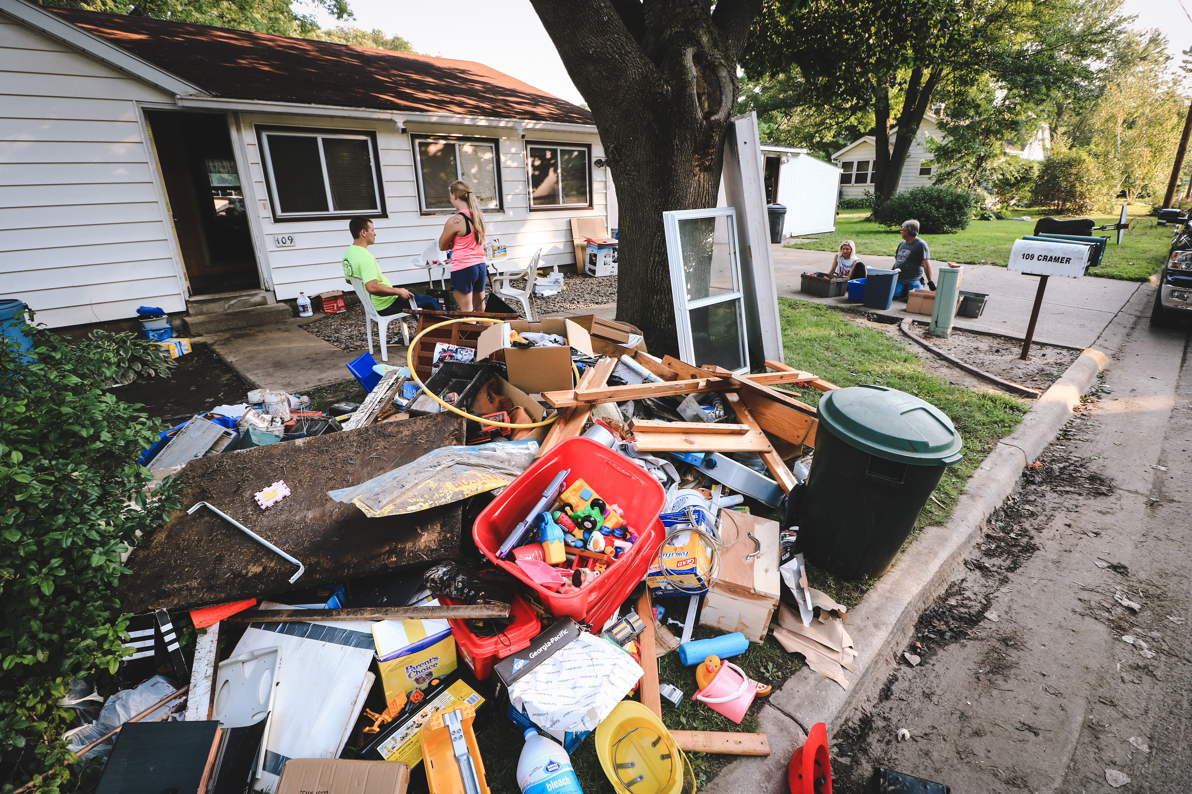 Piles of damaged personal belongings fill the streets of Mazomanie following the flooding.