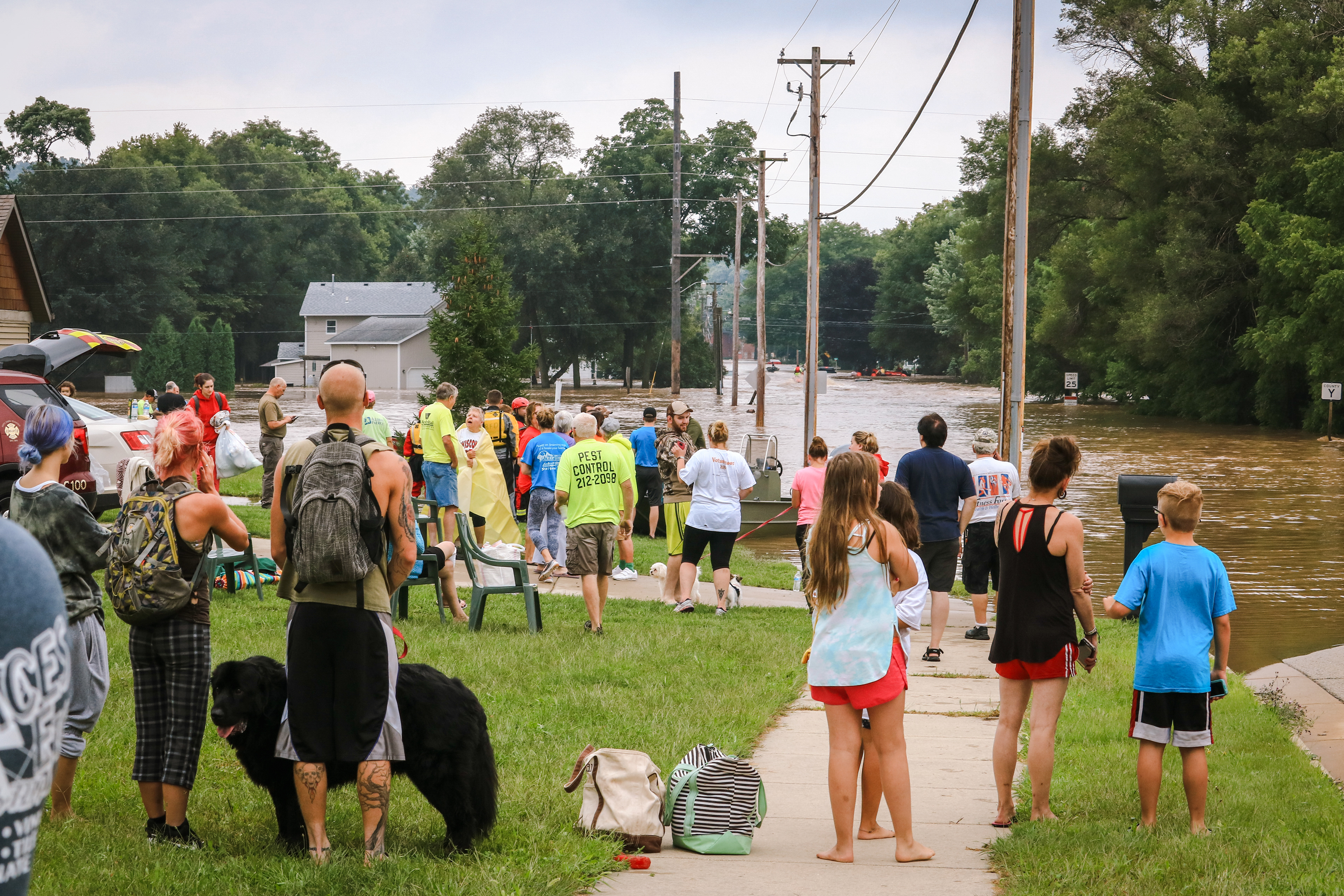 Dozens of flood victims gather at the corner of State and E North Street.