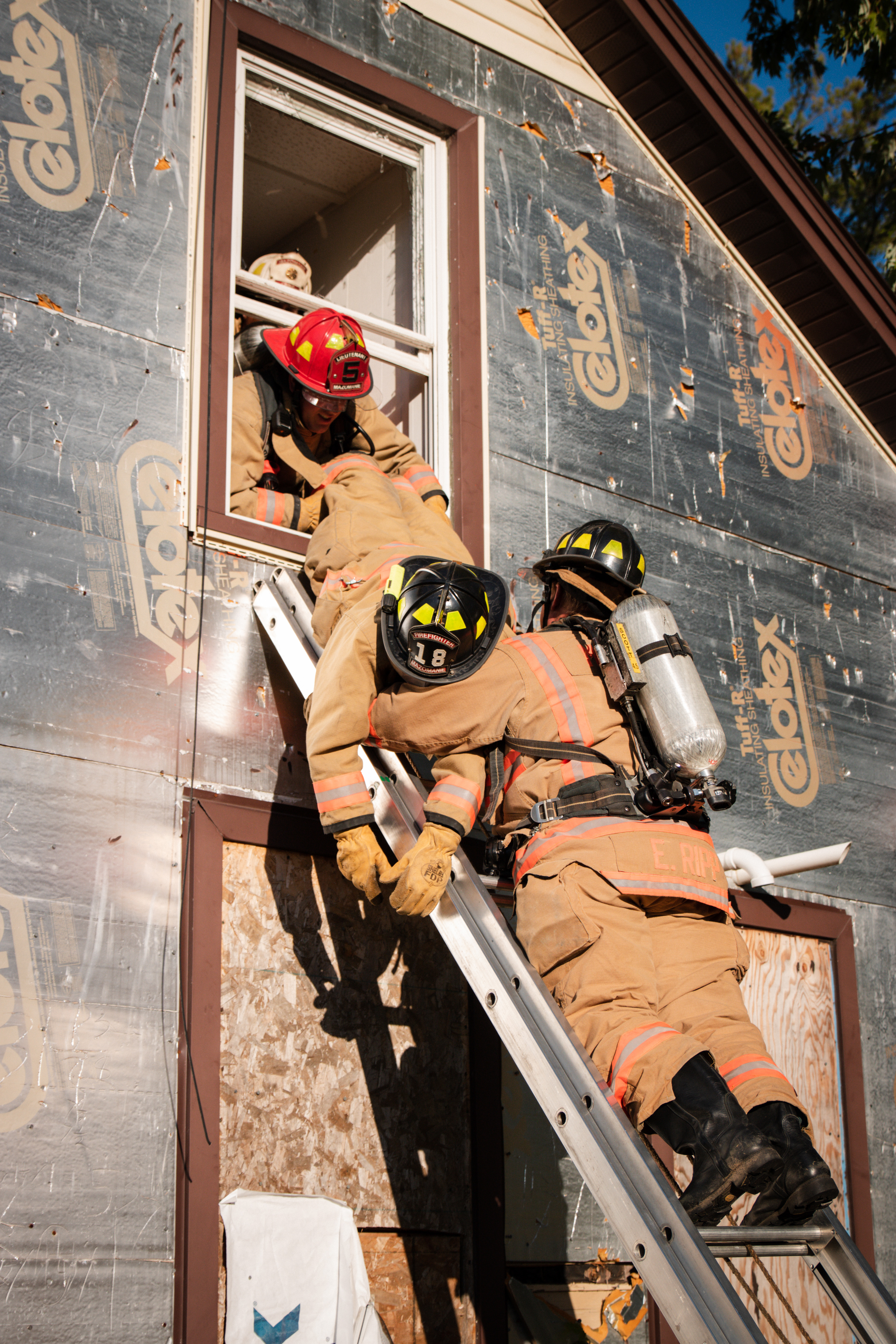 Mazomanie Firefighter 18, Linda Weber, acts as a civilian being rescued from a burning home.