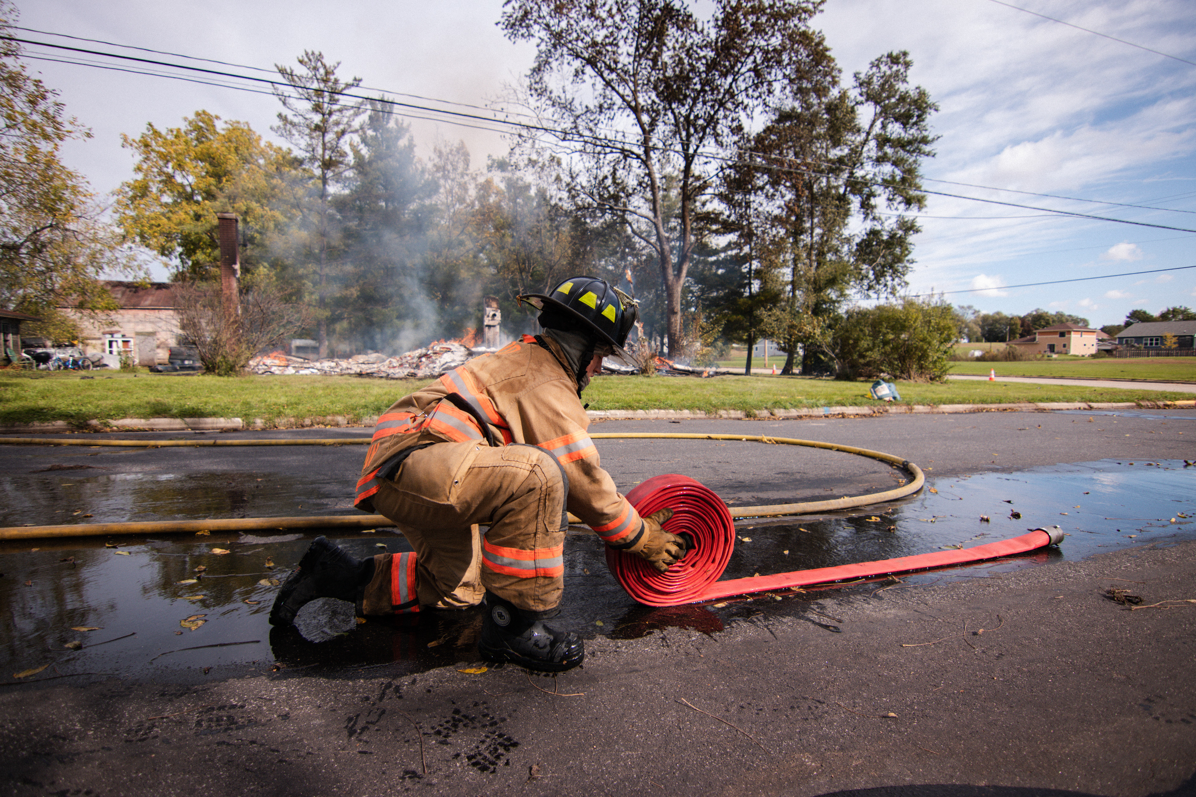 Mazomanie Firefighter, Camden Parman, packs fire equipment after a day on a controlled burn.