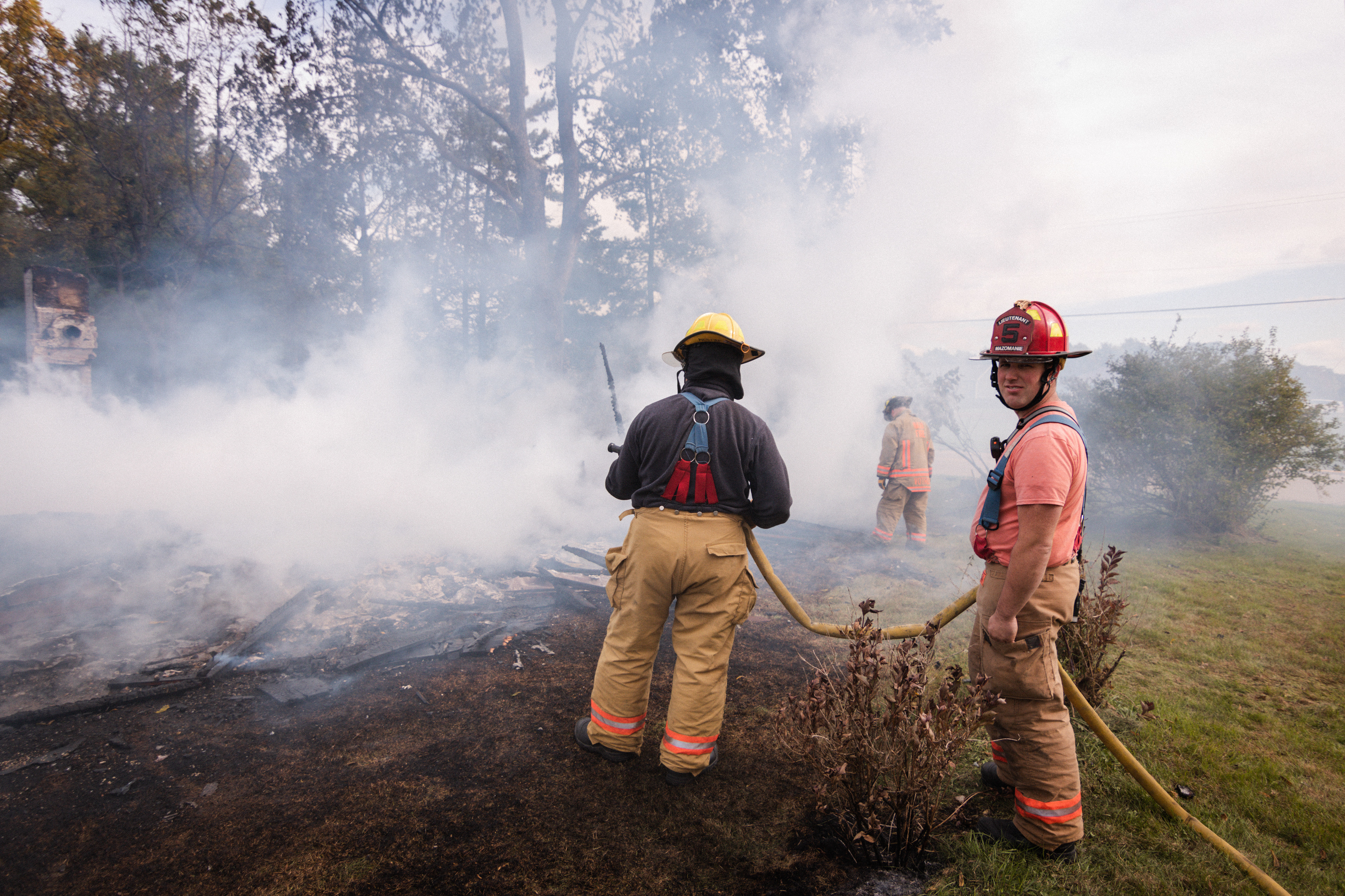 (L to R) Probationary Firefighter, Mike Keller, being assisted by Lieutenant, Peter Gates.