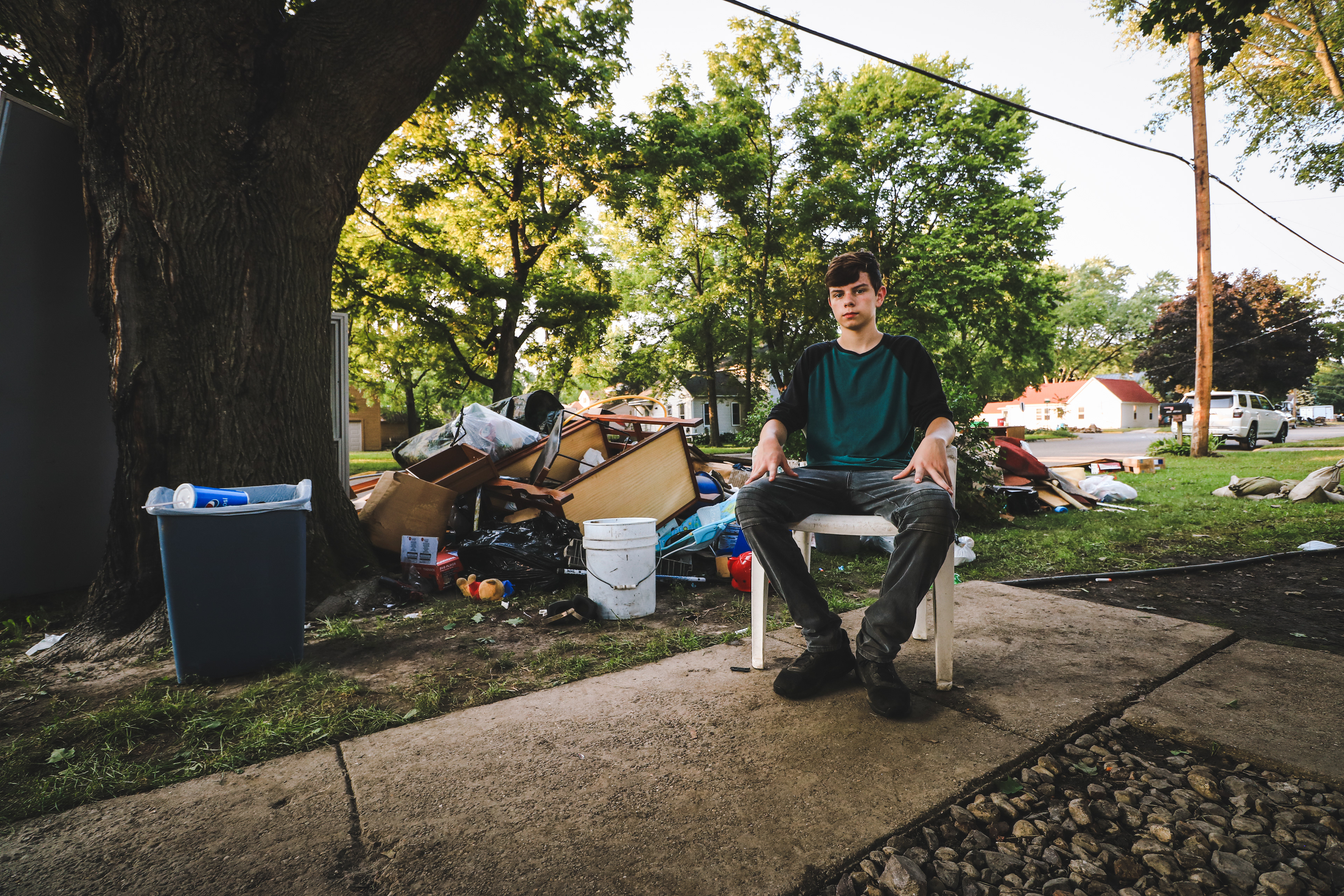 Mitchell Travis takes a self portrait in front of his families destroyed personal belongings.