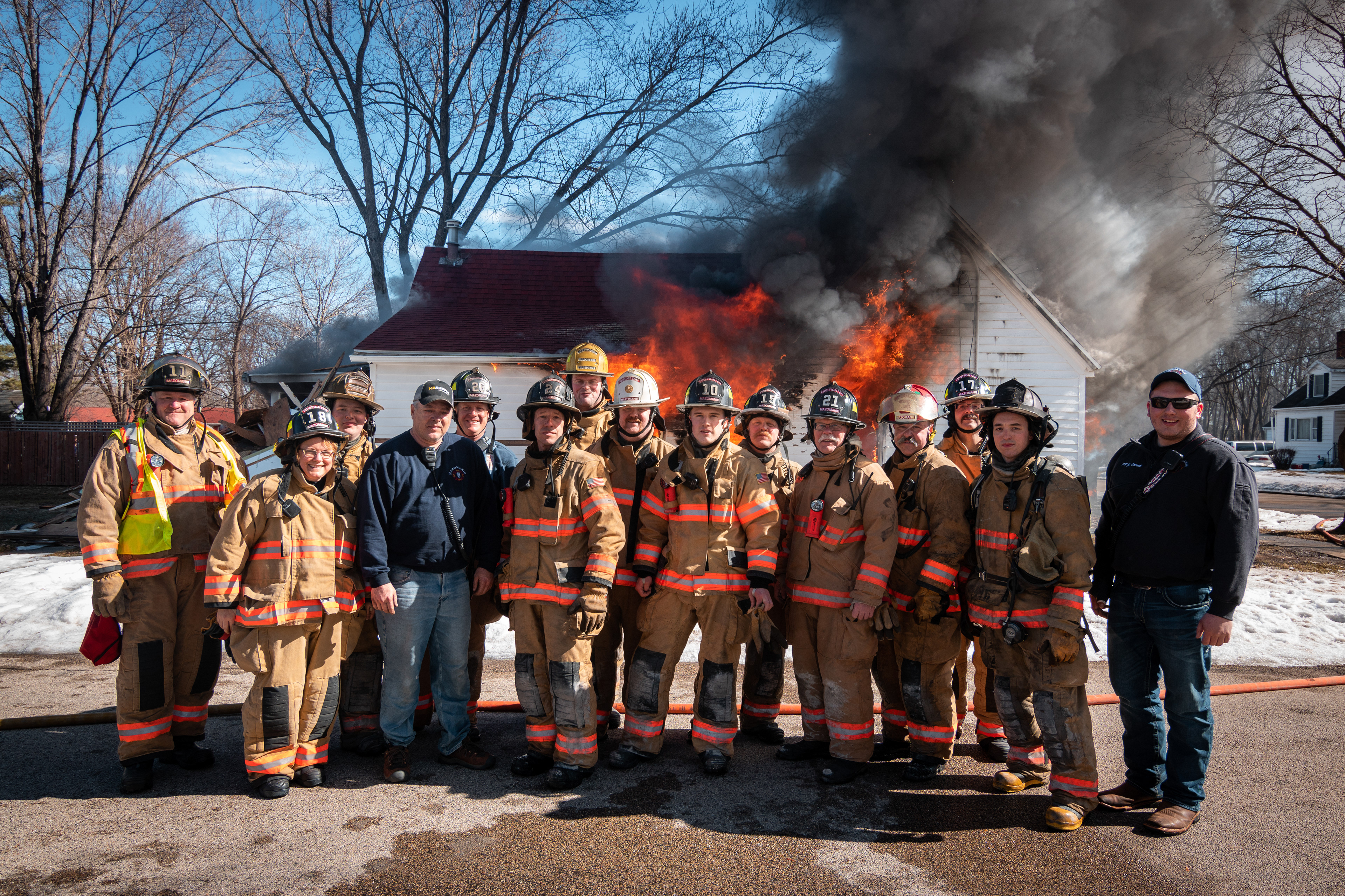 The Mazomanie Fire Department gathers for a photo after performing a controlled burn on a flood damaged home as it was no longer habitable.