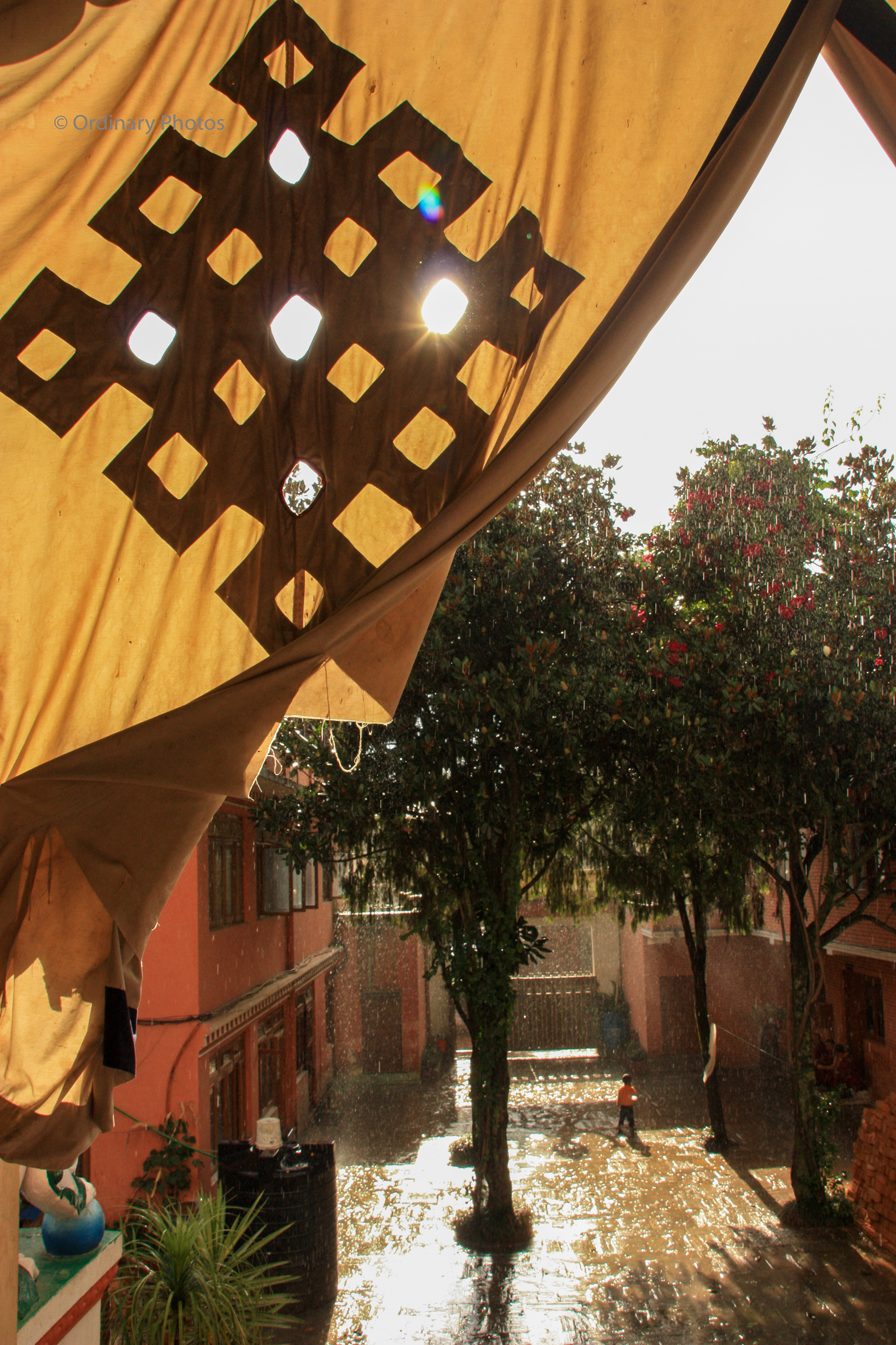 Sun and rain seen from within a monastery in Nepal