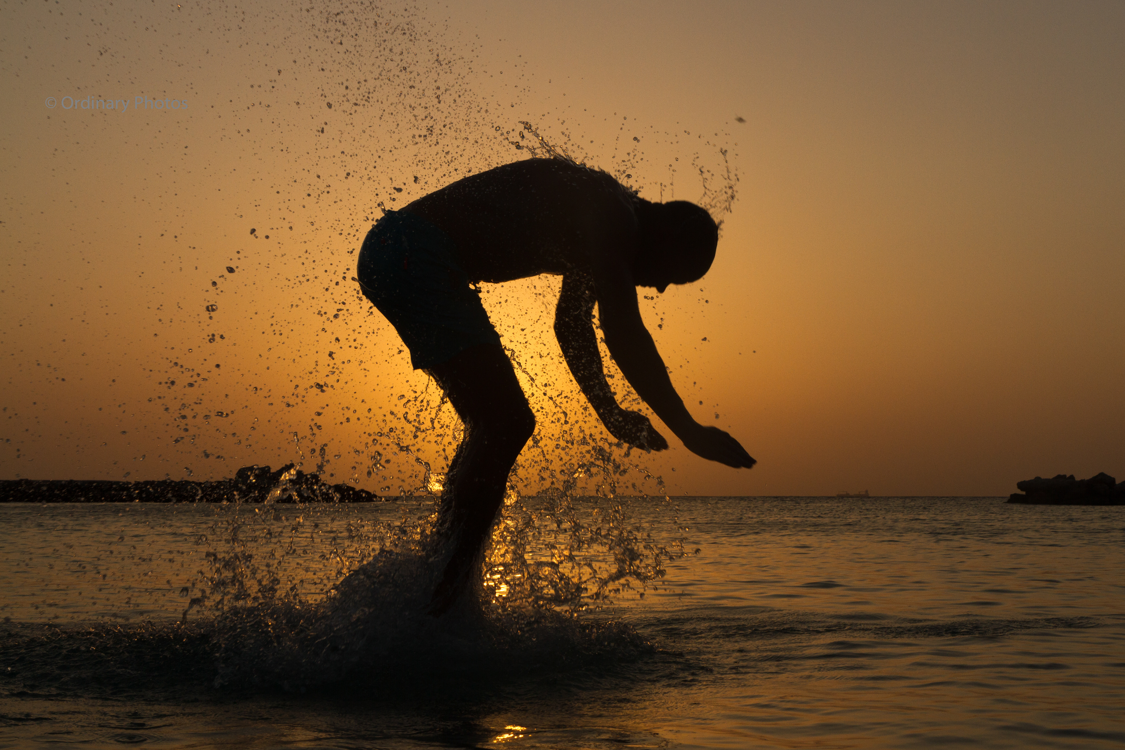 Jumping silhouette in the water near Mambo Beach on Curaçao