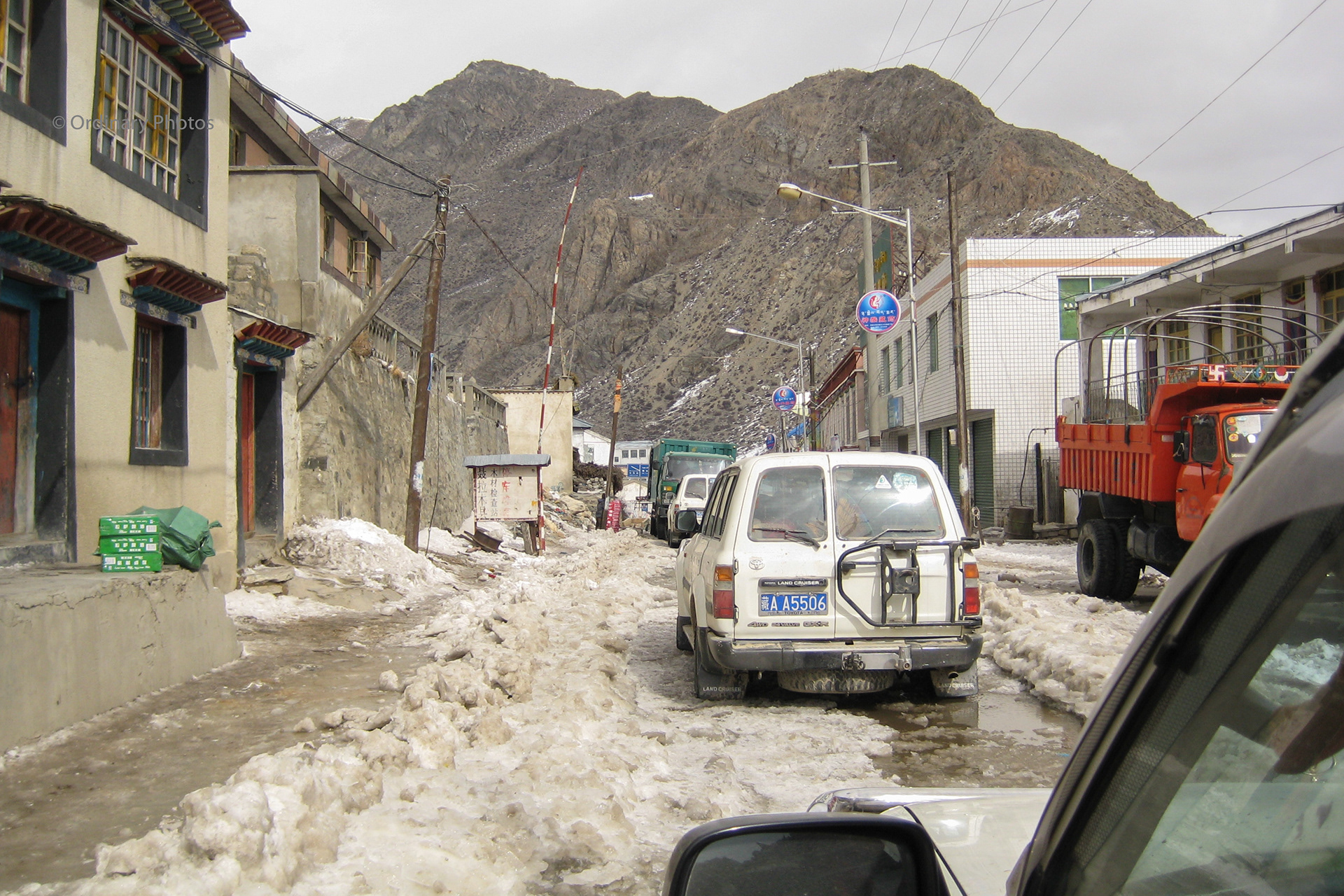 Driving through a small Tibetan village over tough icy roads