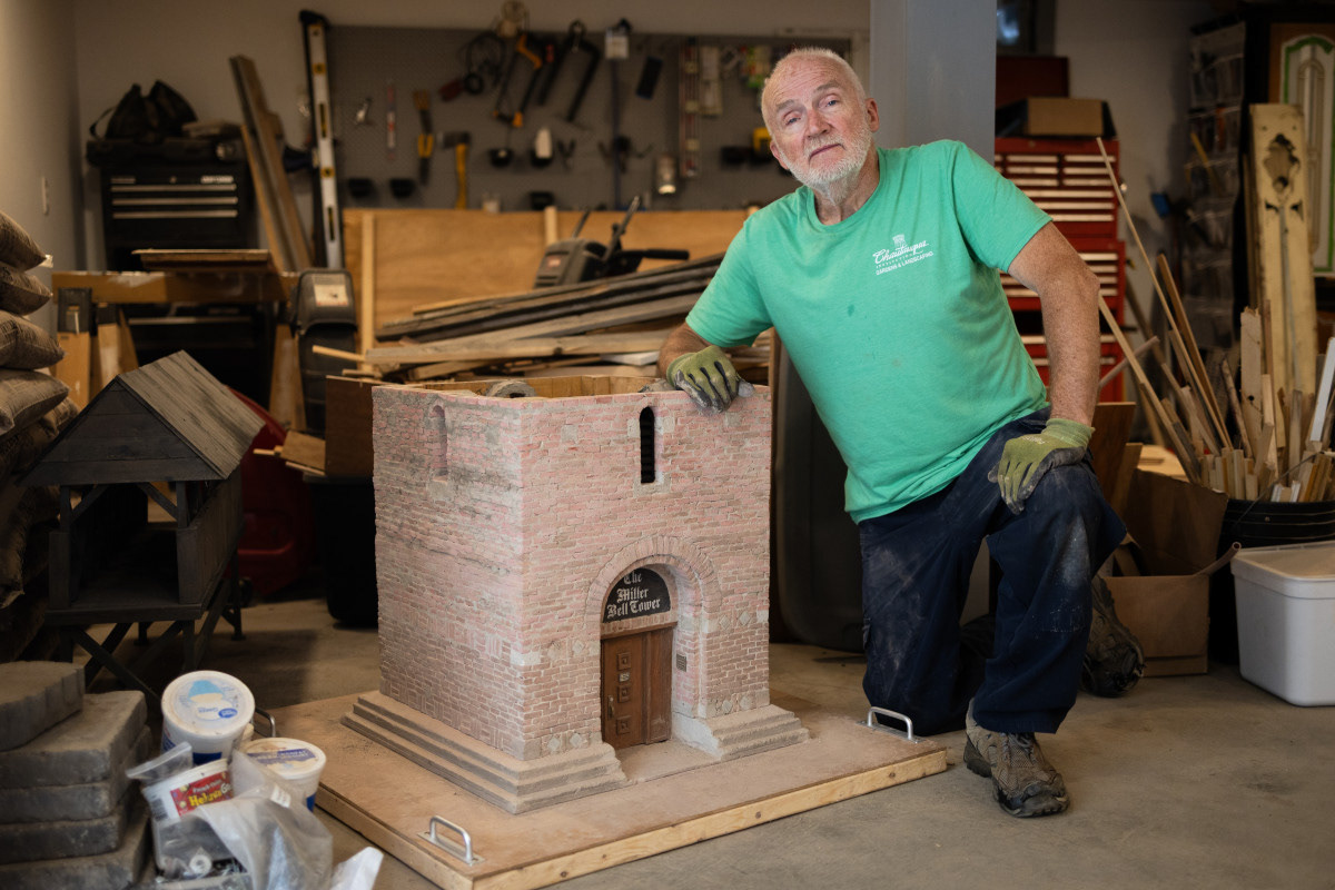 Mark Teets works on his scale-model of the Miller Bell Tower Tuesday in his home workshop. Teets lays each brick by hand, and makes them in bulk with rubber molds. He plans for the final model to be about 6 feet tall.