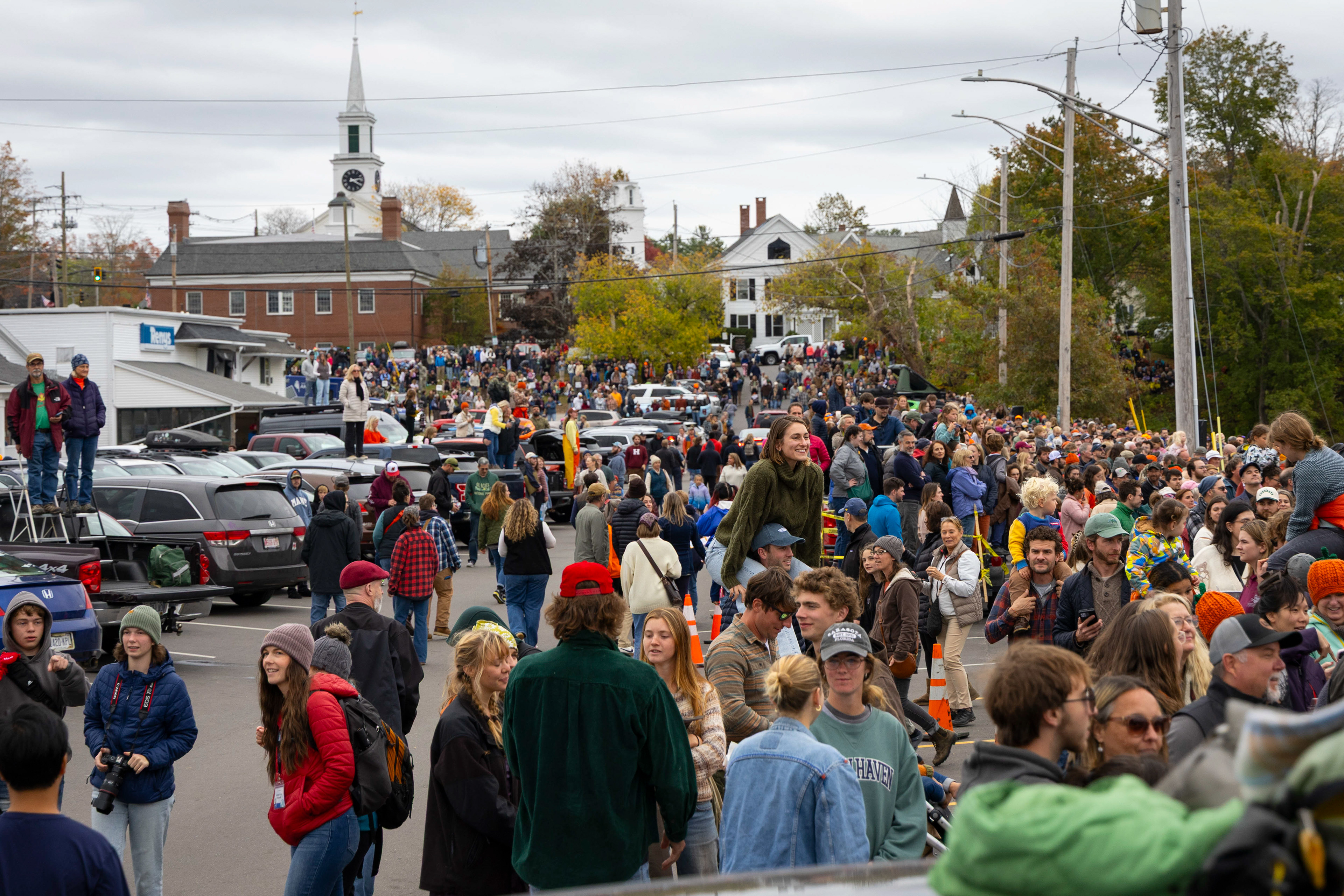 Thousands of spectators gather on the banks of the Damariscotta river during the annual Damariscotta pumpkin festival and regatta to watch the racers compete on Sunday, October 12, 2025 in Damariscotta, Maine. Participants spend two to three days hallowing out their pumpkins – which weigh upwards of 600 pounds – before they are delivered to the water by forklift.