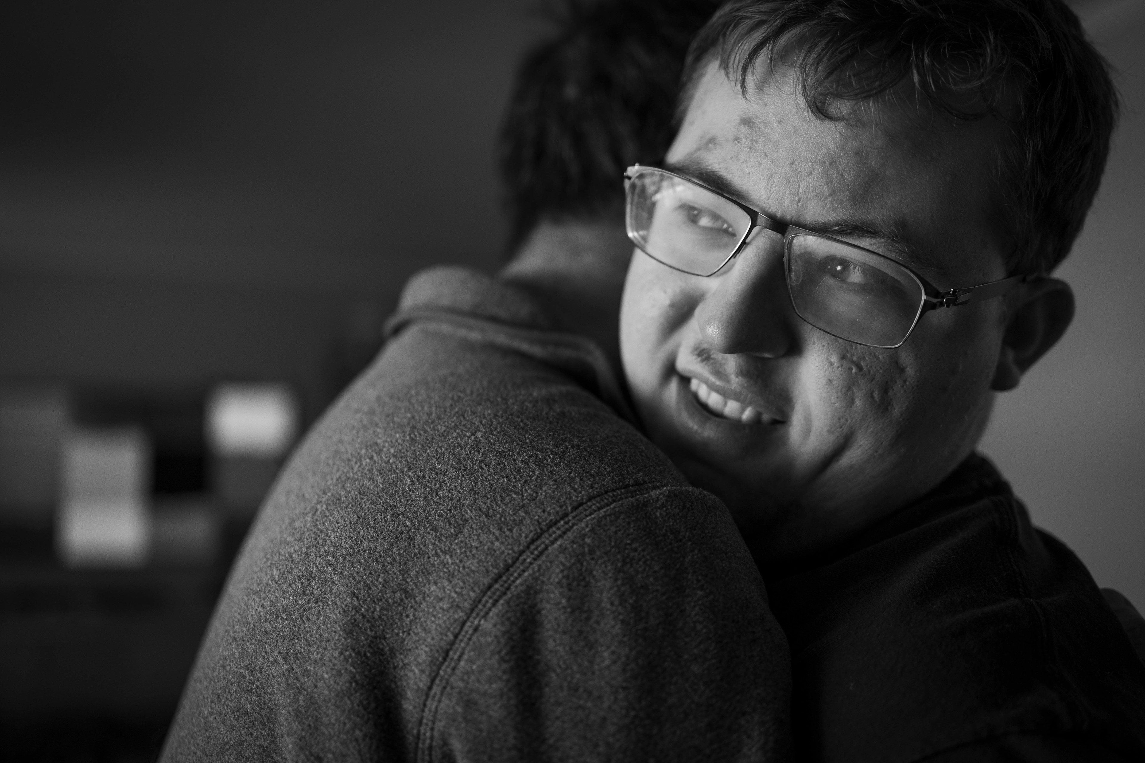 Evan, right, embraces his father, Peter Koloski on Monday, November 17, 2025. Spontaneous hugs are not uncommon in the Koloski household.