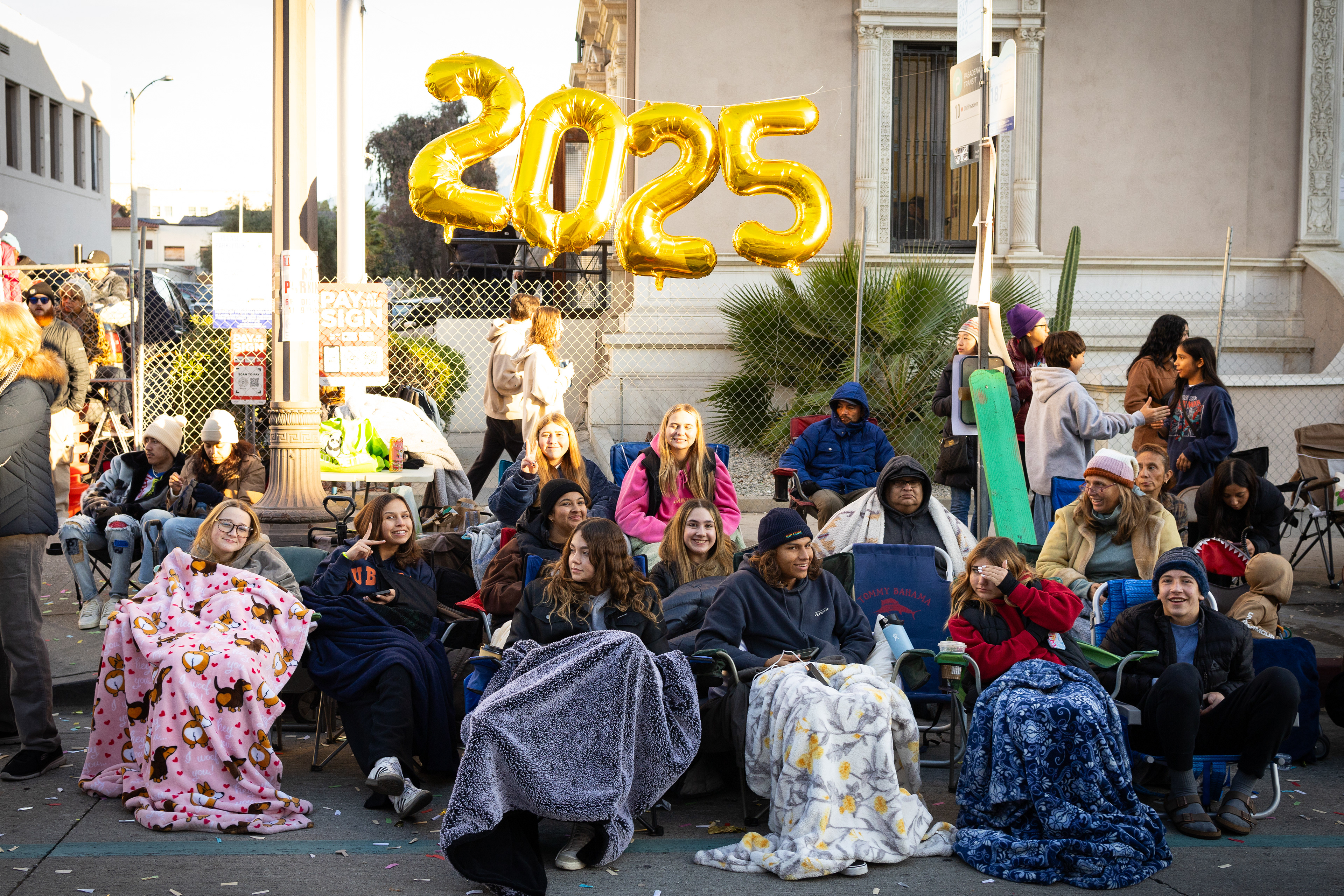 A group of parade-goers arrive to the route early to get the best view for watching the annual Tournament of Roses Parade on January 1, 2025.