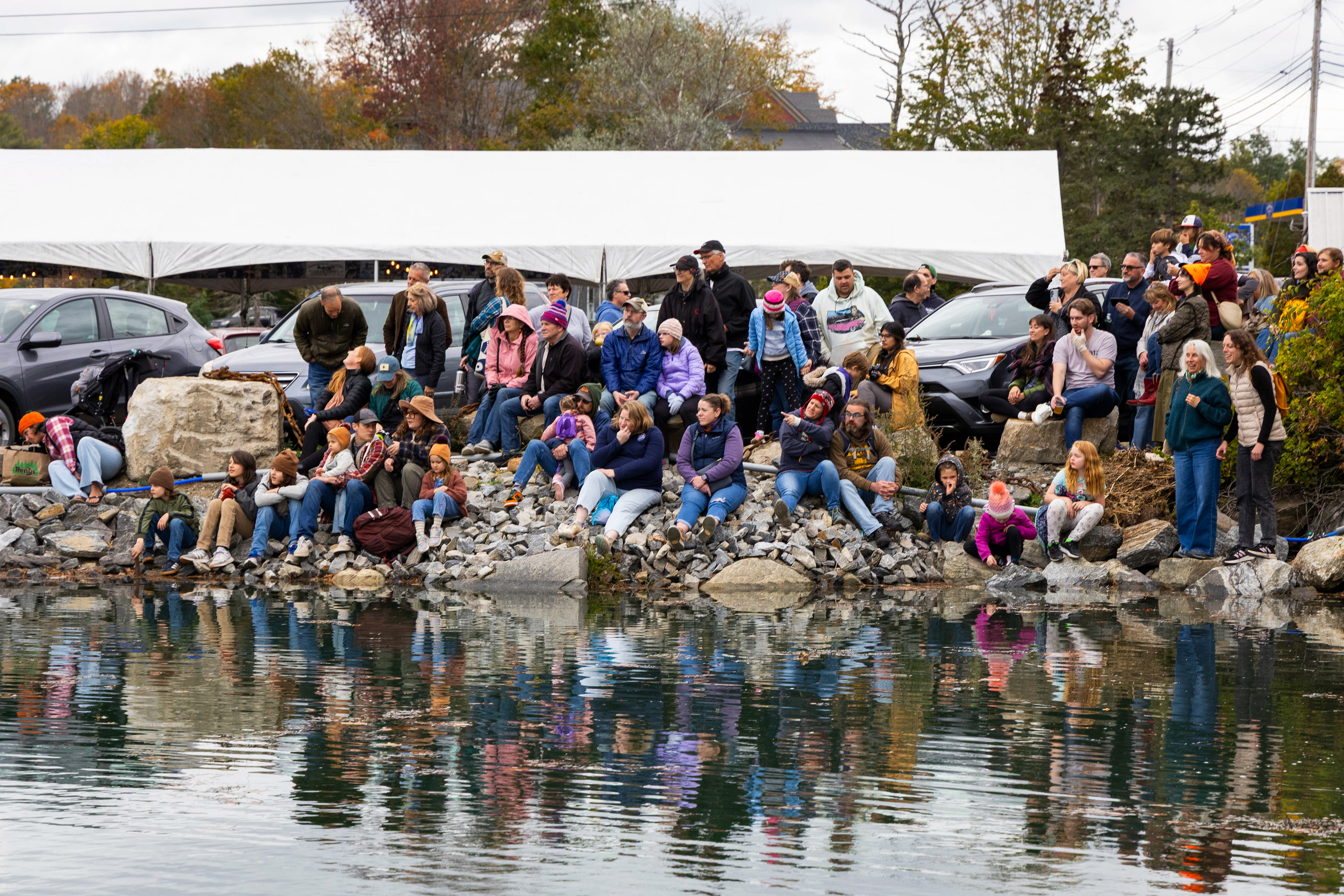 Spectators gather on the banks of the river for the best possible view.