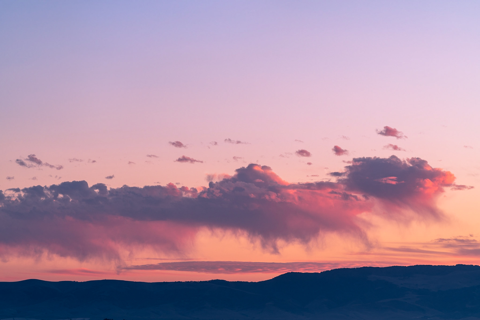 This was taken looking across the Santa Maria valley from Nipomo California. These clouds looked like their structure at the top of the group was breaking apart and falling down onto the hills below. The focal length chosen frames this group of clouds and the color grading highlightes the beautiful tones produced by this sunset.