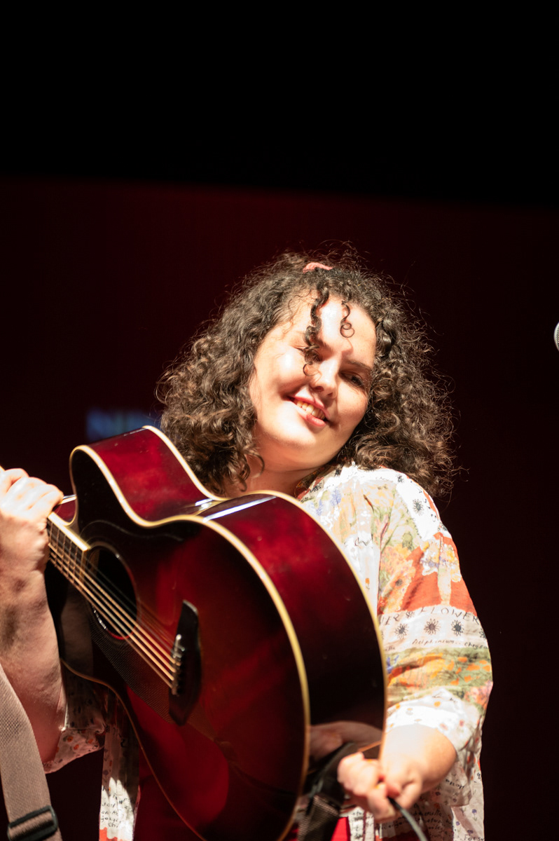 singer with a guitar and friendly smile