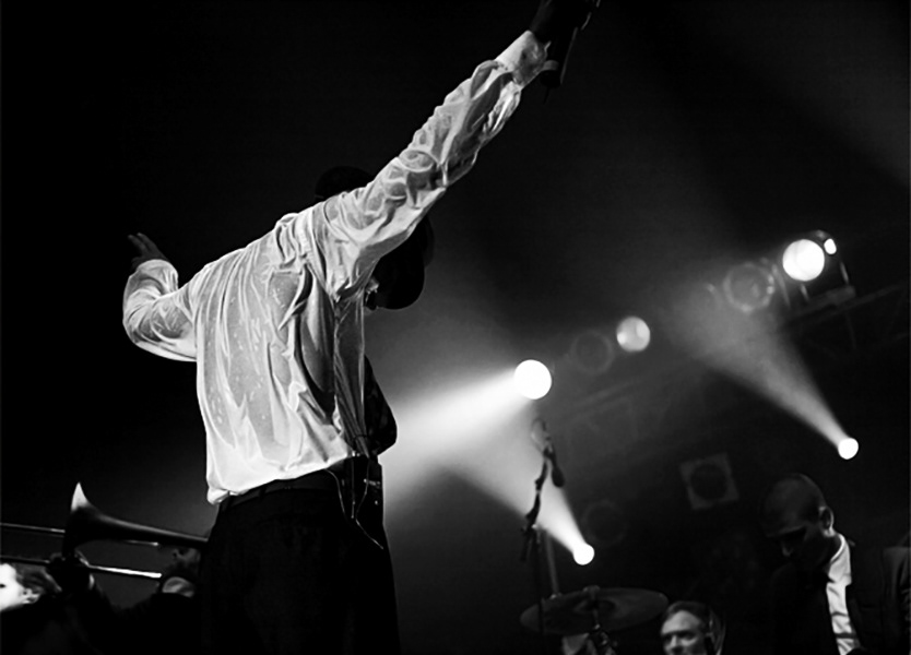 jan delay, musician. backsite at the end of a concert. total sweaty shirt
