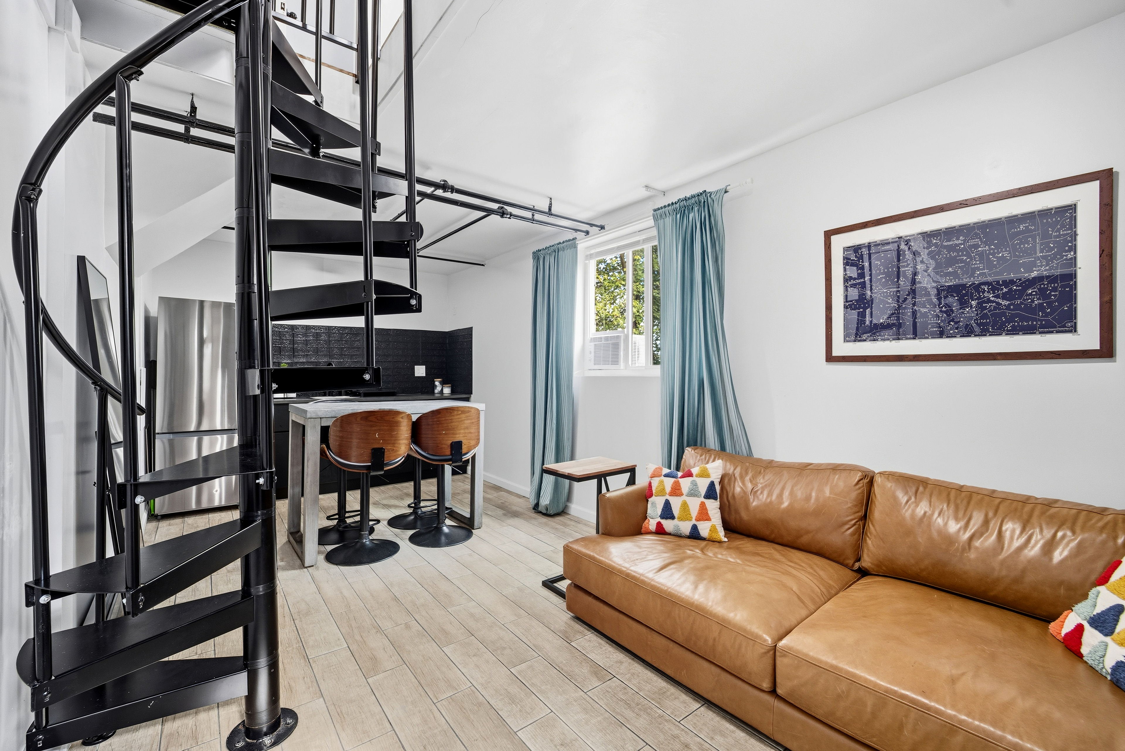 Inside the main living area, featuring a spiral staircase up to the 2nd floor.