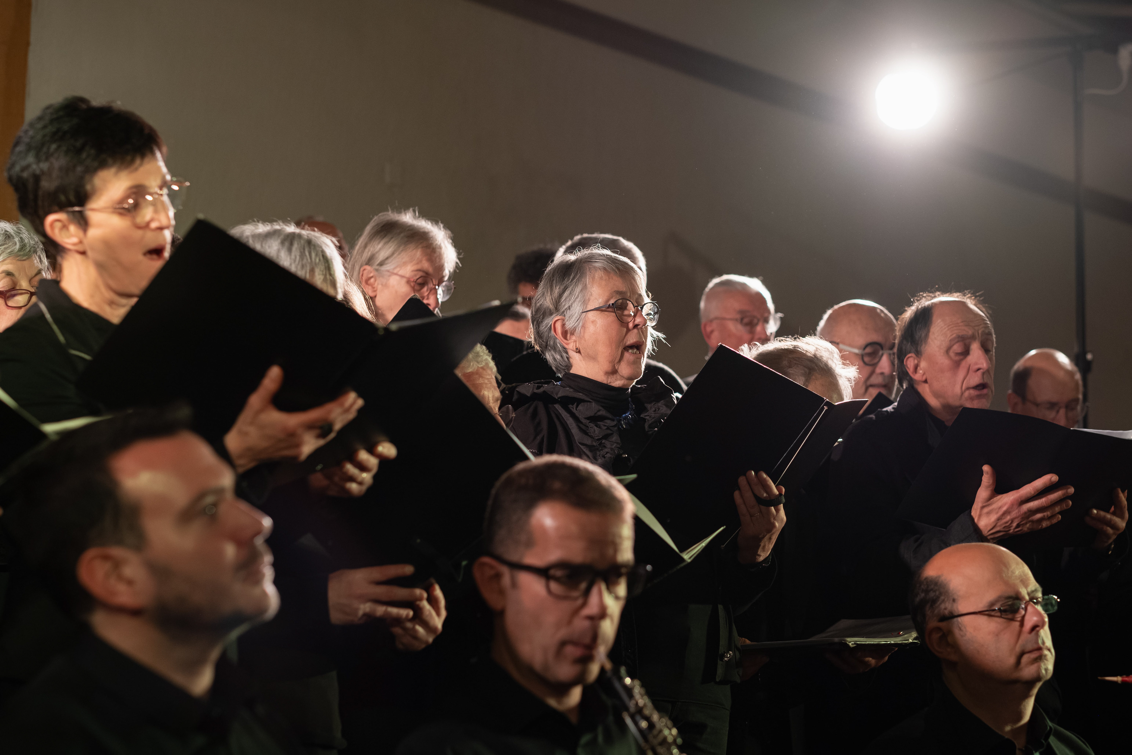 Membres d'une chorale en concert, chantant avec émotion à Mâcon, Saône-et-Loire, Bourgogne, Rhône-Alpes. Photographie capturée par Etienne Gatheron. Photographie institutionnelle.
