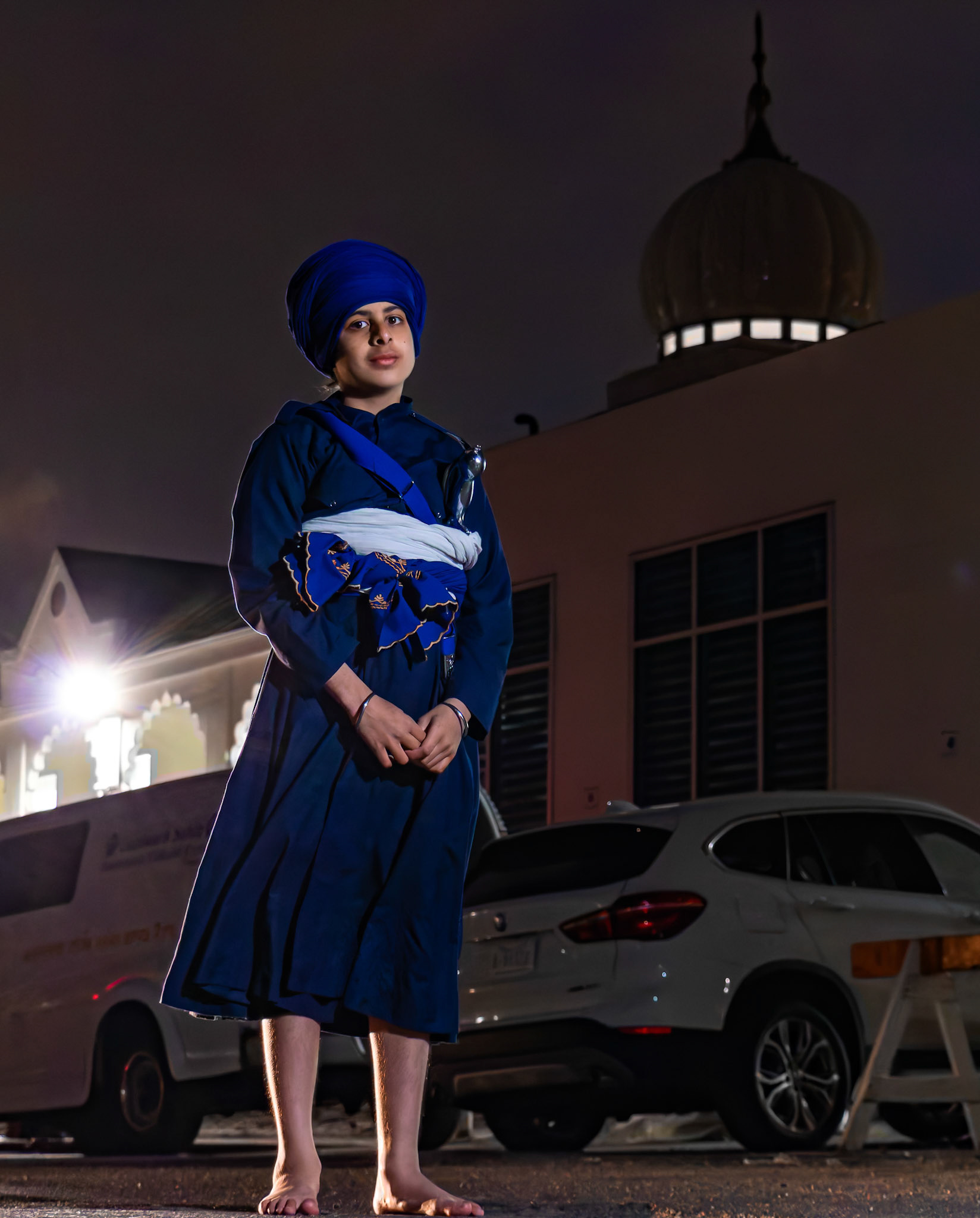 Komal Singh Sandhu, 11, born and raised in Calgary to immigrant parents from Punjab, poses for a portrait at Dashmesh Culture Centre (DCC), a Sikh place of worship named after Guru Gobind Singh Ji, located in the community of Martindale, NE Calgary, on Monday, April 15, 2024. Komal recently embarked on a significant journey in his Sikh faith by participating in the Amrit Chhanna or 'drinking the nectar' ceremony yesterday afternoon. According to his grandmother, by taking this step, he follows in the footsteps of generations past and is now on the path to becoming Amritdhari (baptized Sikh). “Members who take Amrit are bound by a common set of principles and wear the five Ks: Kesh (uncut hair), Kangha (comb), Kachera (shorts), Kara (steel bracelet), and Kirpan (small sword).” He also loves watching movies in theatres and playing soccer. (Photo by Armaan Khanna/The Press)