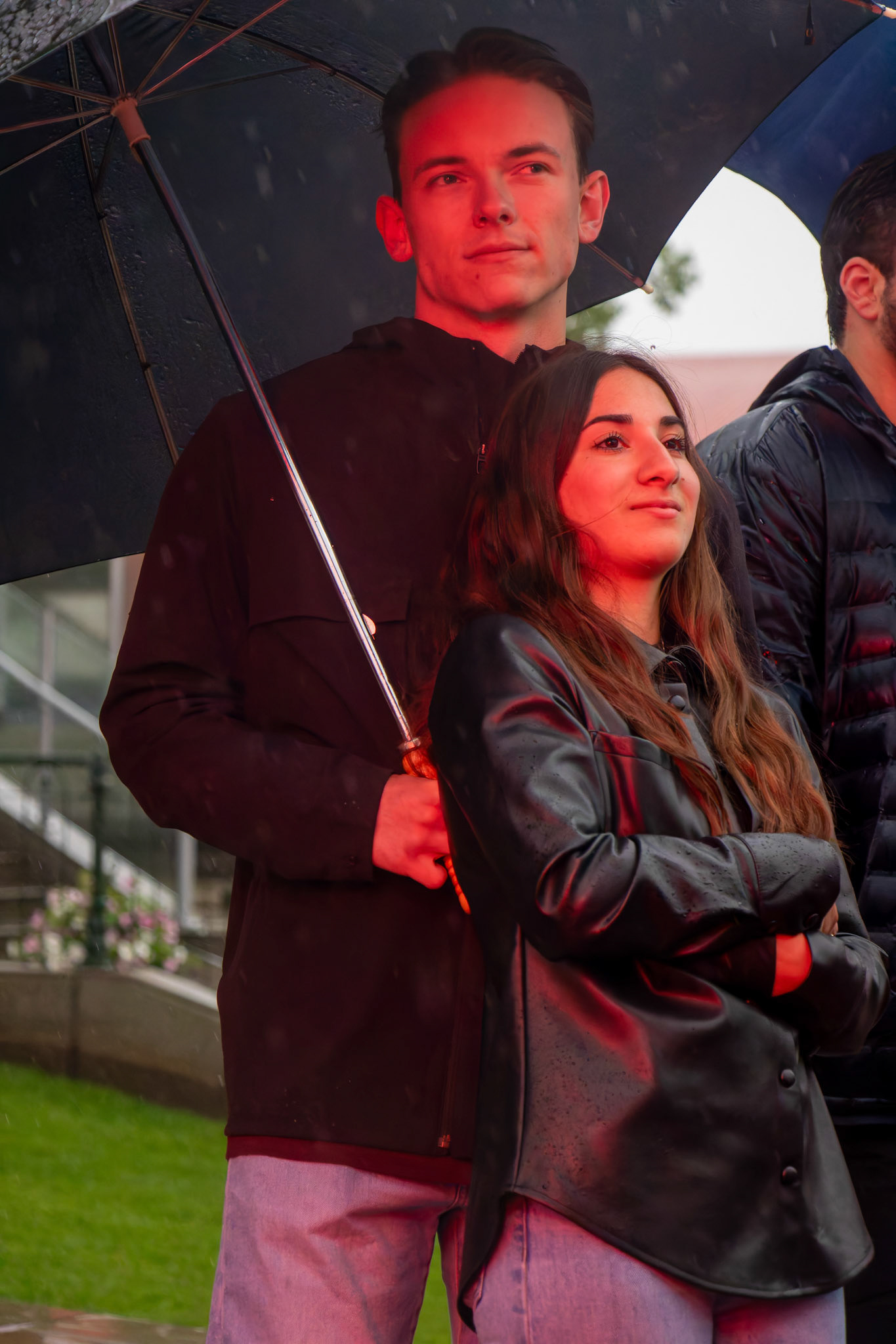 Matt (left) and Roma, a couple, enjoy the concert in the rain at Spruce Meadows, SW Calgary, on Saturday, June 15, 2024. Spruce Meadows is renowned for hosting top-tier equestrian competitions, such as the 'National' tournament, held from June 12 to 16, 2024. (Photo by Armaan Khanna/SAIT)