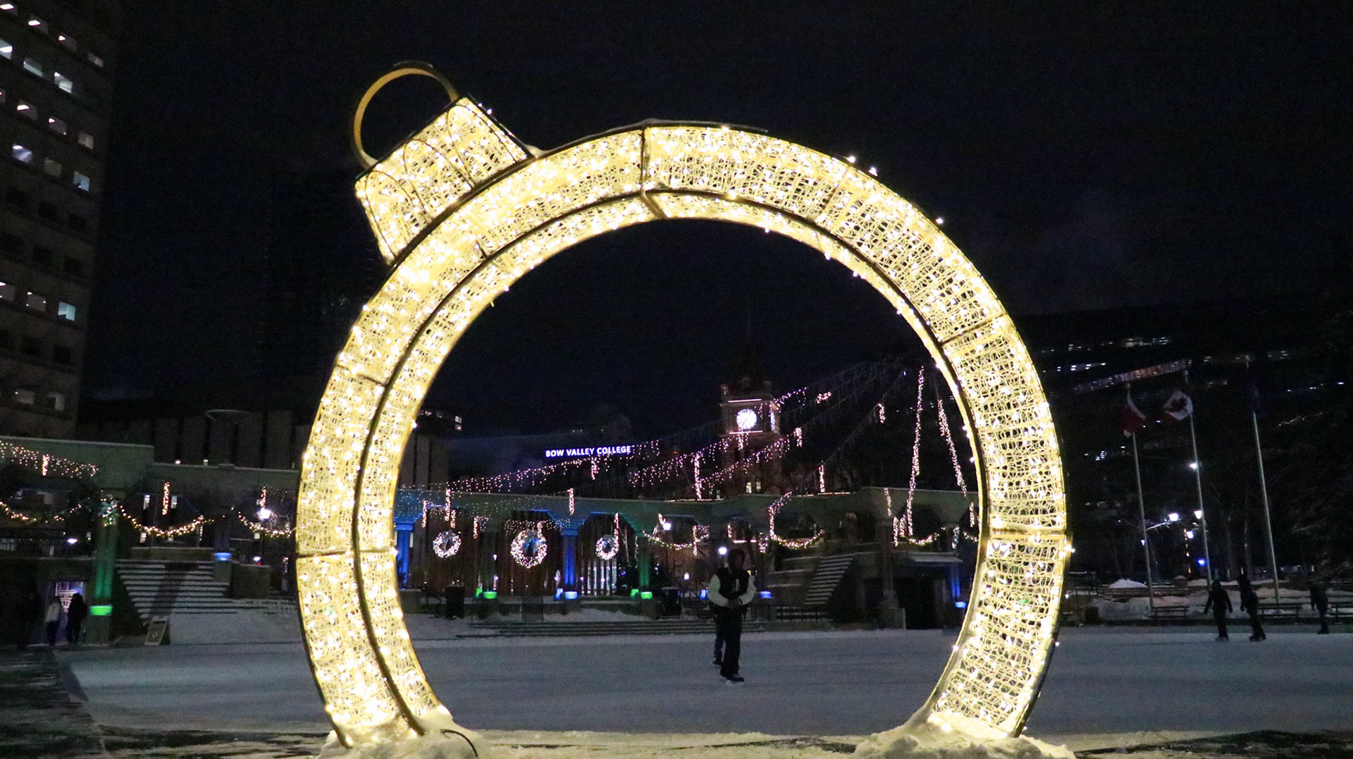 This photo displays recreational ice skating at Olympic Plaza in downtown Calgary, Alta. The photo was captured in the evening on Friday, Jan. 19, 2024, around 6:00 PM. -23°C isn’t too cold for these Calgarians to not go outside for ice skating. This shot captures a person enjoying ice skating while using the bright sculpture as the frame, with the iconic Calgary City Hall in the background adding to the scene.(Photo by Armaan Khanna/The Press)