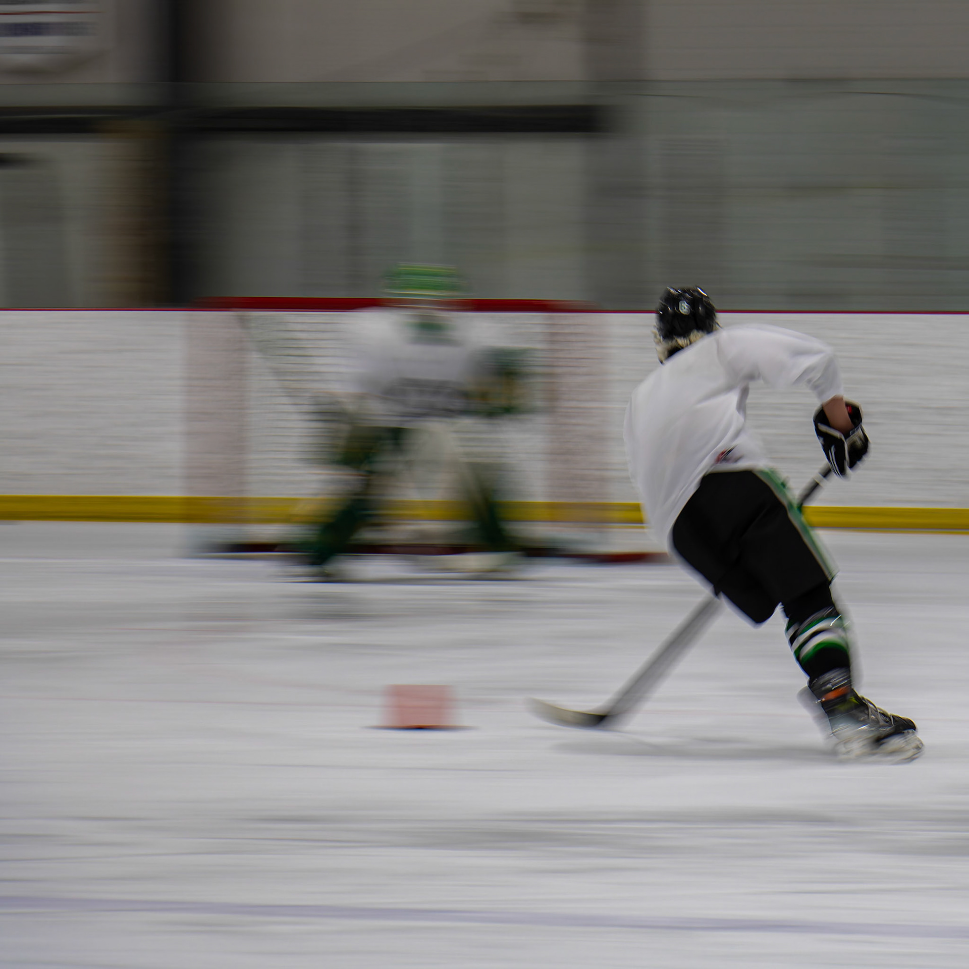 Ice hockey player shoots the puck as the goalie makes a save during a practice drill at the Chestermere Recreation Centre, Alta. on Tuesday, April 9, 2024. Ice hockey is a fast-paced sport that holds a special place in Canadian culture, similar to cricket in India or football (soccer) in Argentina. (Photo by Armaan Khanna/SAIT)