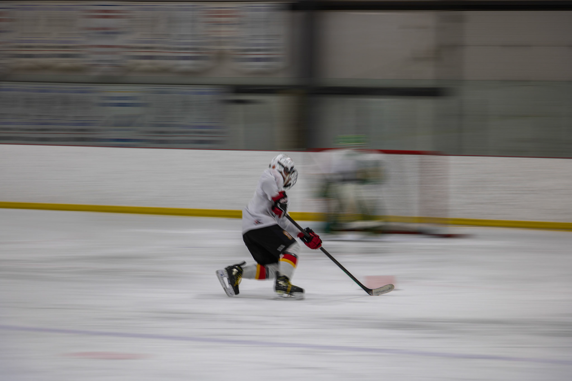 Ice hockey player shoots the puck as the goalie makes a save during a practice drill at the Chestermere Recreation Centre, Alta. on Tuesday, April 9, 2024. Ice hockey is a fast-paced sport that holds a special place in Canadian culture, similar to cricket in India or football (soccer) in Argentina. (Photo by Armaan Khanna/SAIT)