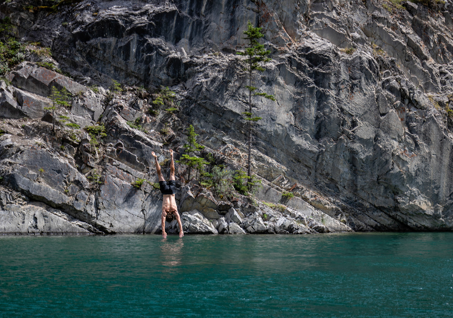 Reon White jumps off a cliff into Whitemans Pond, Canmore on Saturday (July 13). ARMAAN KHANNA RMO PHOTO