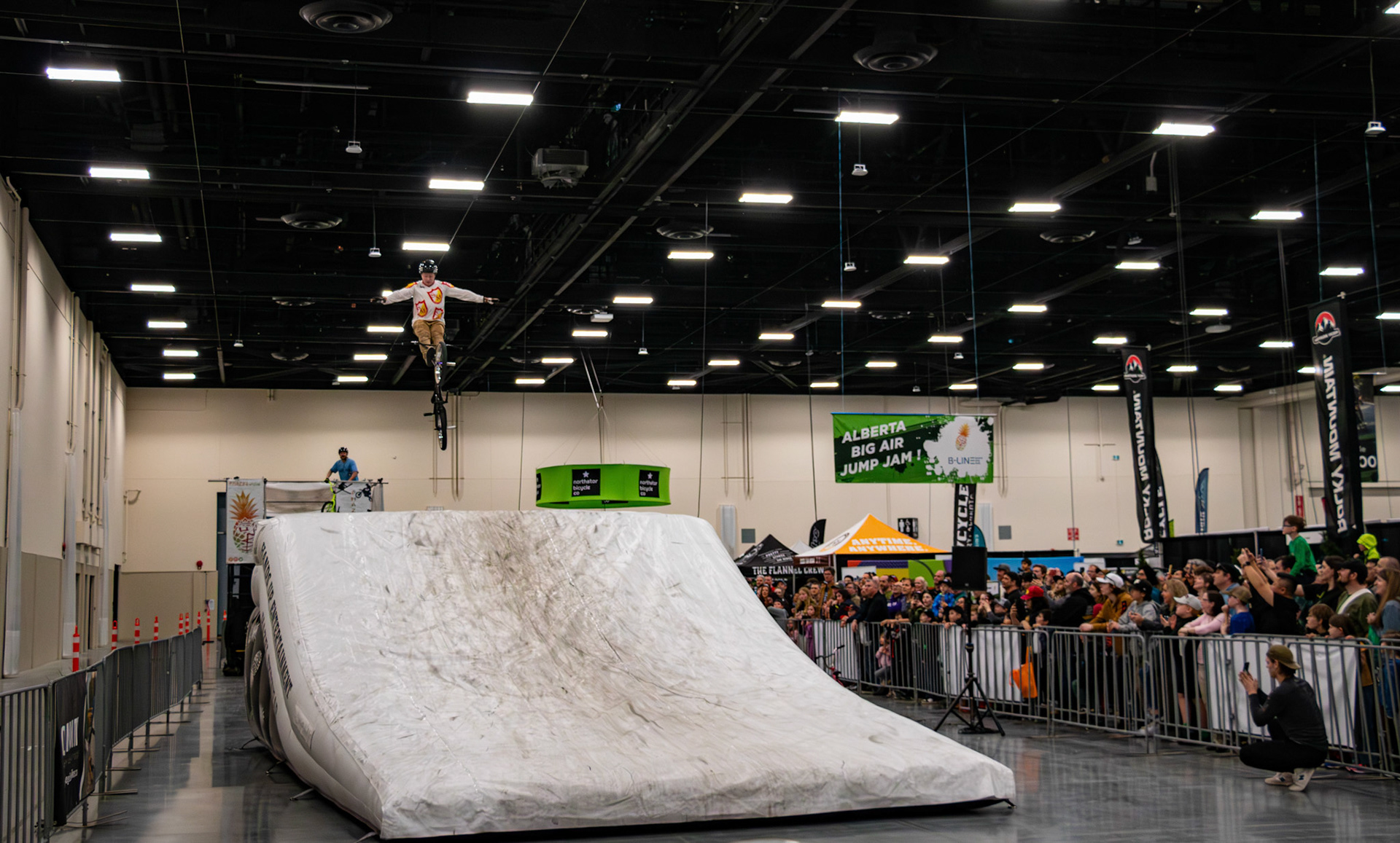Professional bikers showcase thrilling stunts and tricks on the jump ramp at the Alberta Bike Show at BMO Centre, Calgary on Sunday, March 17, 2024. The Alberta Bike Show provides an incredible experience for cyclists and provides an opportunity to explore the latest bikes. (Photo by Armaan Khanna/The Press)