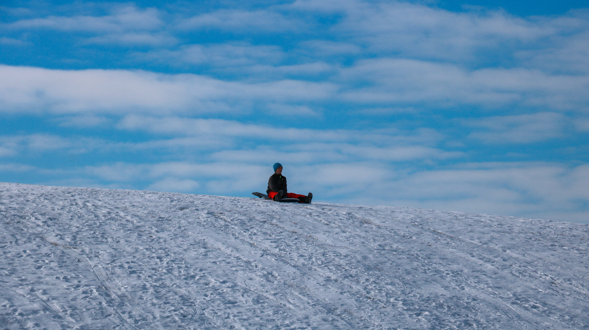 People enjoy tobogganing in the Praire Winds Park, N.E. Calgary on Thursday, Feb. 15, 2024. The temperature outside was around -6°C. The camera shutter speed was set to 1/800. (Photo by Armaan Khanna/The Press)