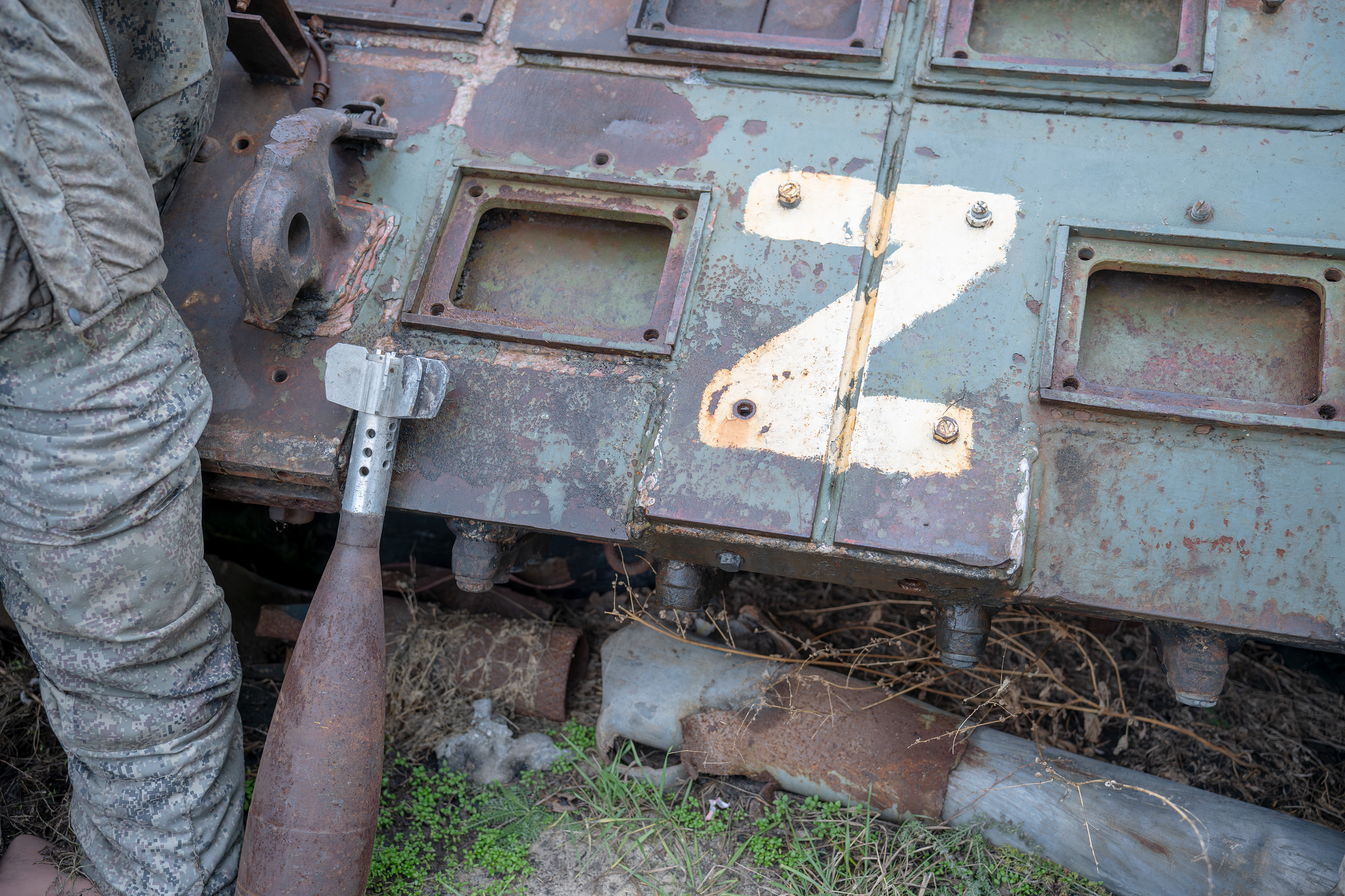 The remains of a Russian tank and a mortar round are displayed alongside a dummy dressed in a Russian forces uniform in Kharkiv, Ukraine. The tank's front bears the "Z" insignia, a symbol used by Russian forces. It was destroyed during the Battle of Kharkiv in 2022.