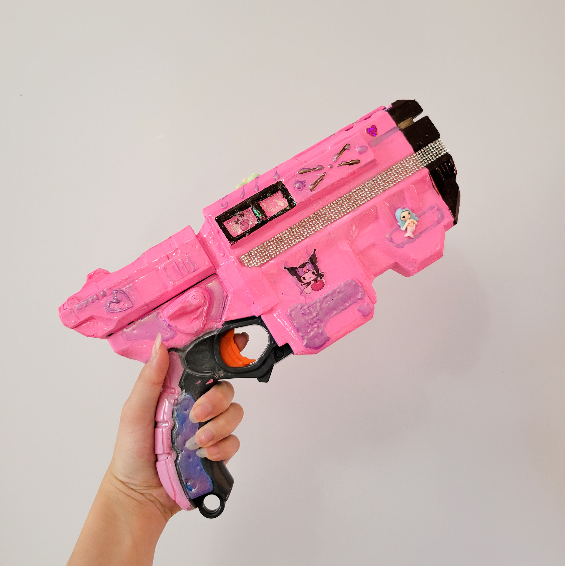 Sheriff Skin | 12" x 6" | Mixed media on toy gun | 2023 | holding