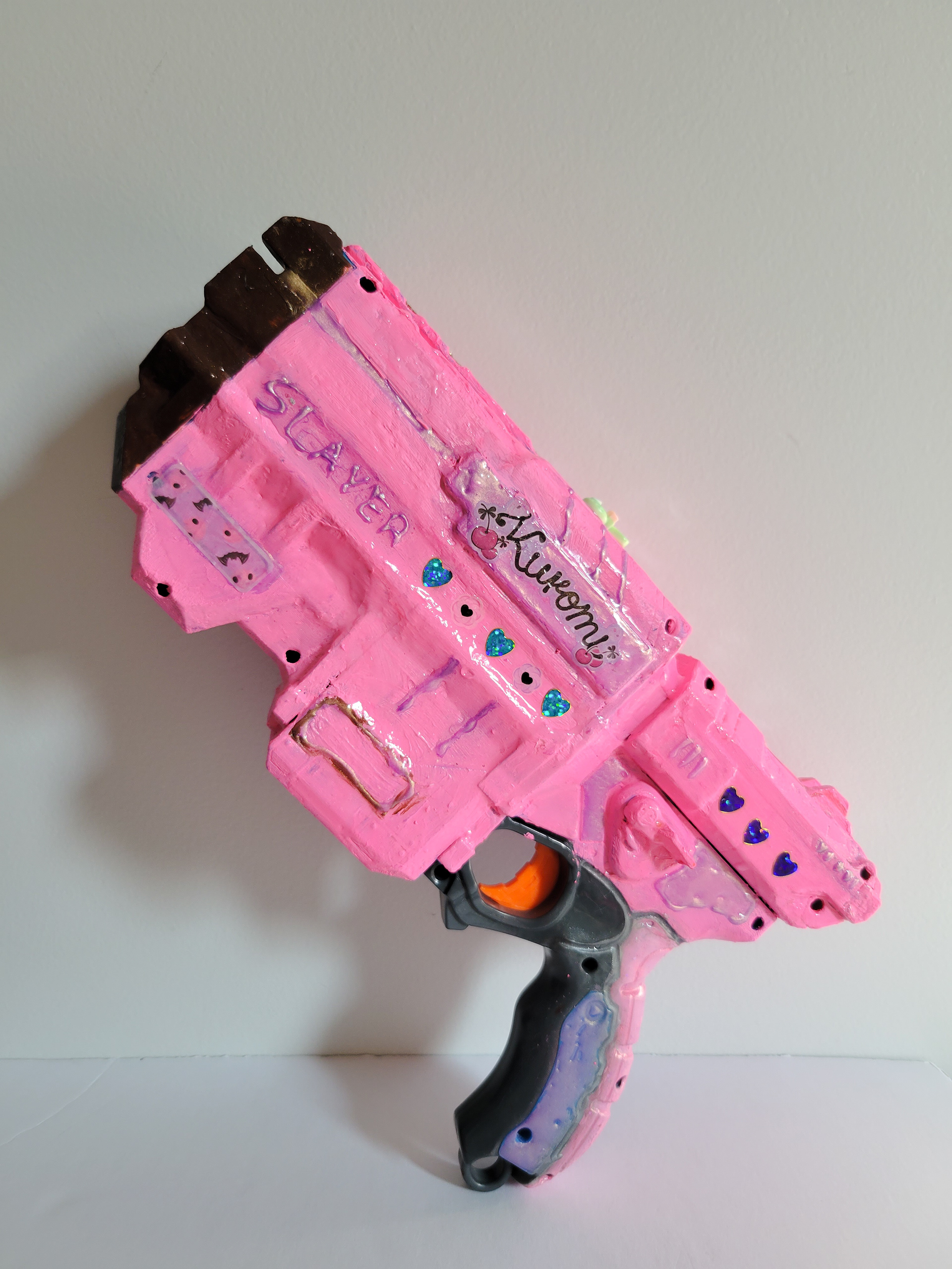 Sheriff Skin | 12" x 6" | Mixed media on toy gun | 2023 | side 2