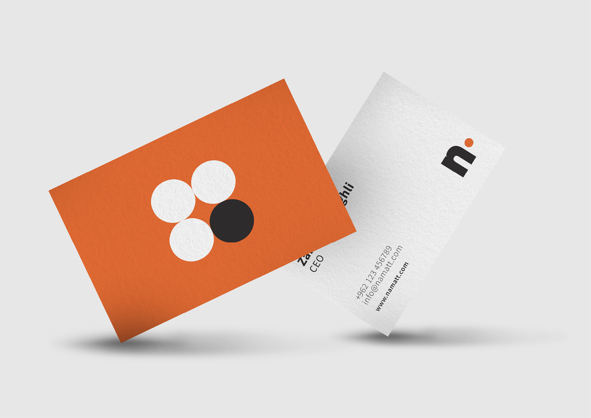NAMATT business card mockups with orange geometric artwork and a white reverse featuring contact details.