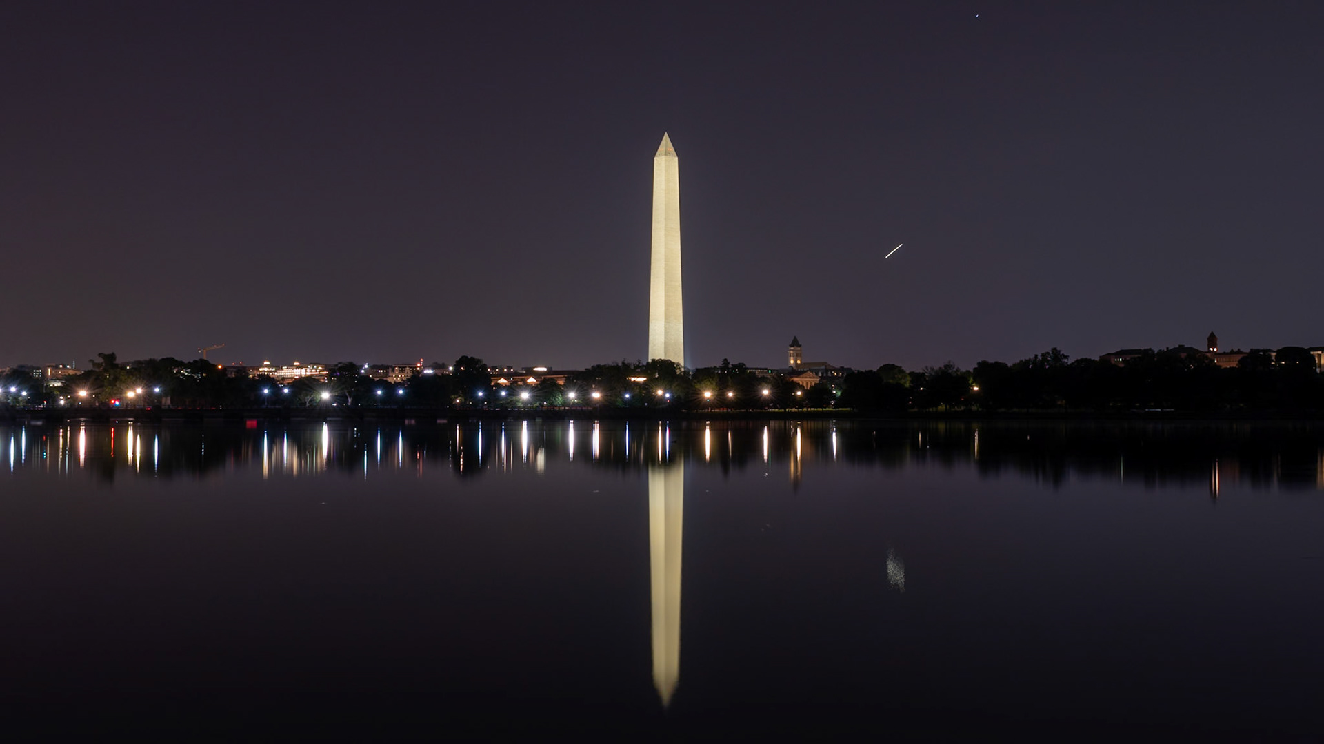 15 second exposure of the Washington Monument from across the Tidal Basin, plane flying in the upper right.