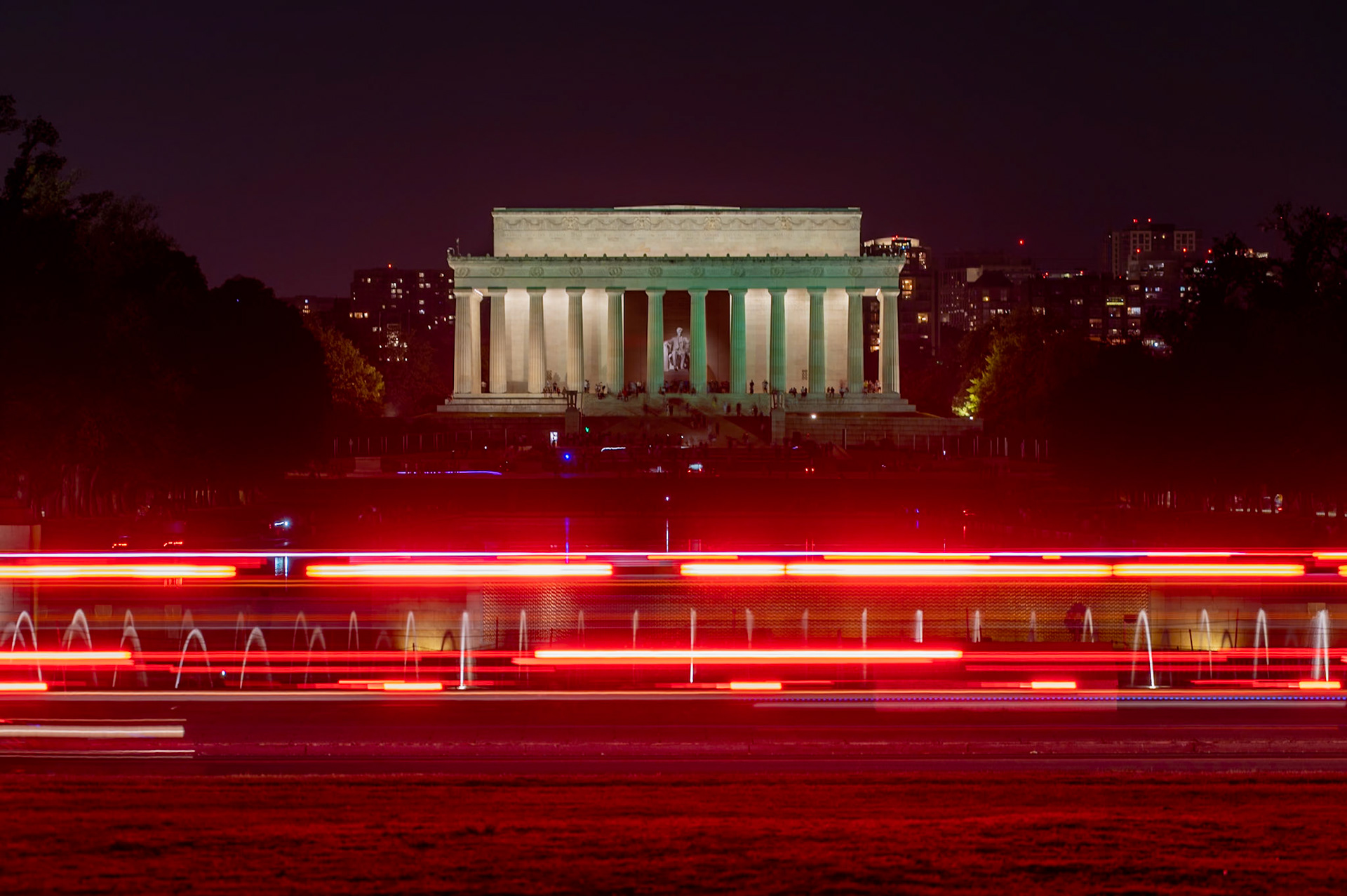 3 second exposure of the Lincoln Memorial from beyond the Reflecting Pool and WWII Memorial.  Ambulance passing in the foreground.  Washington DC.