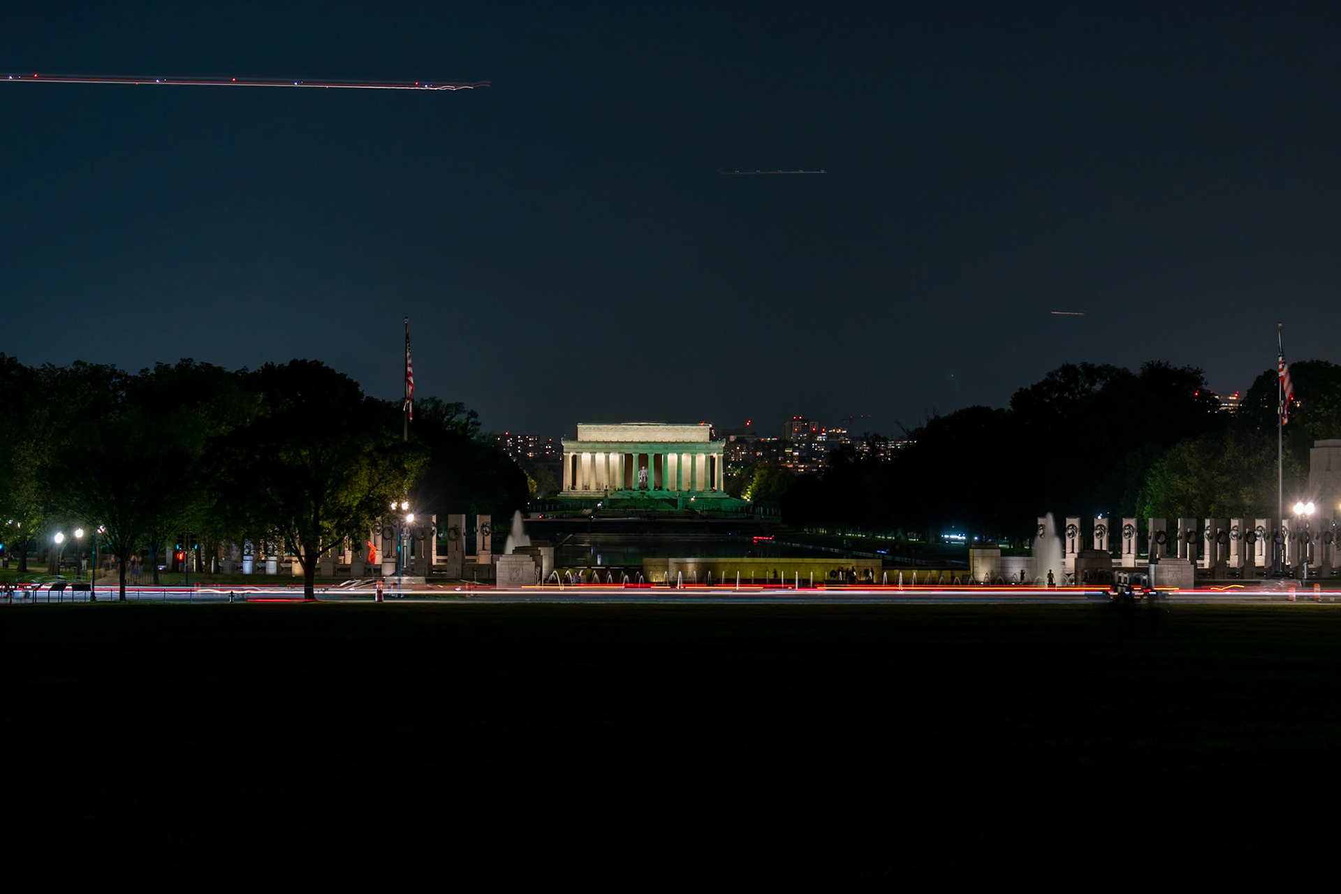 5 second exposure of the Lincoln Memorial from beyond the Reflecting Pool and WWII Memorial.  Multiple planes in the sky overhead.  Washington DC.
