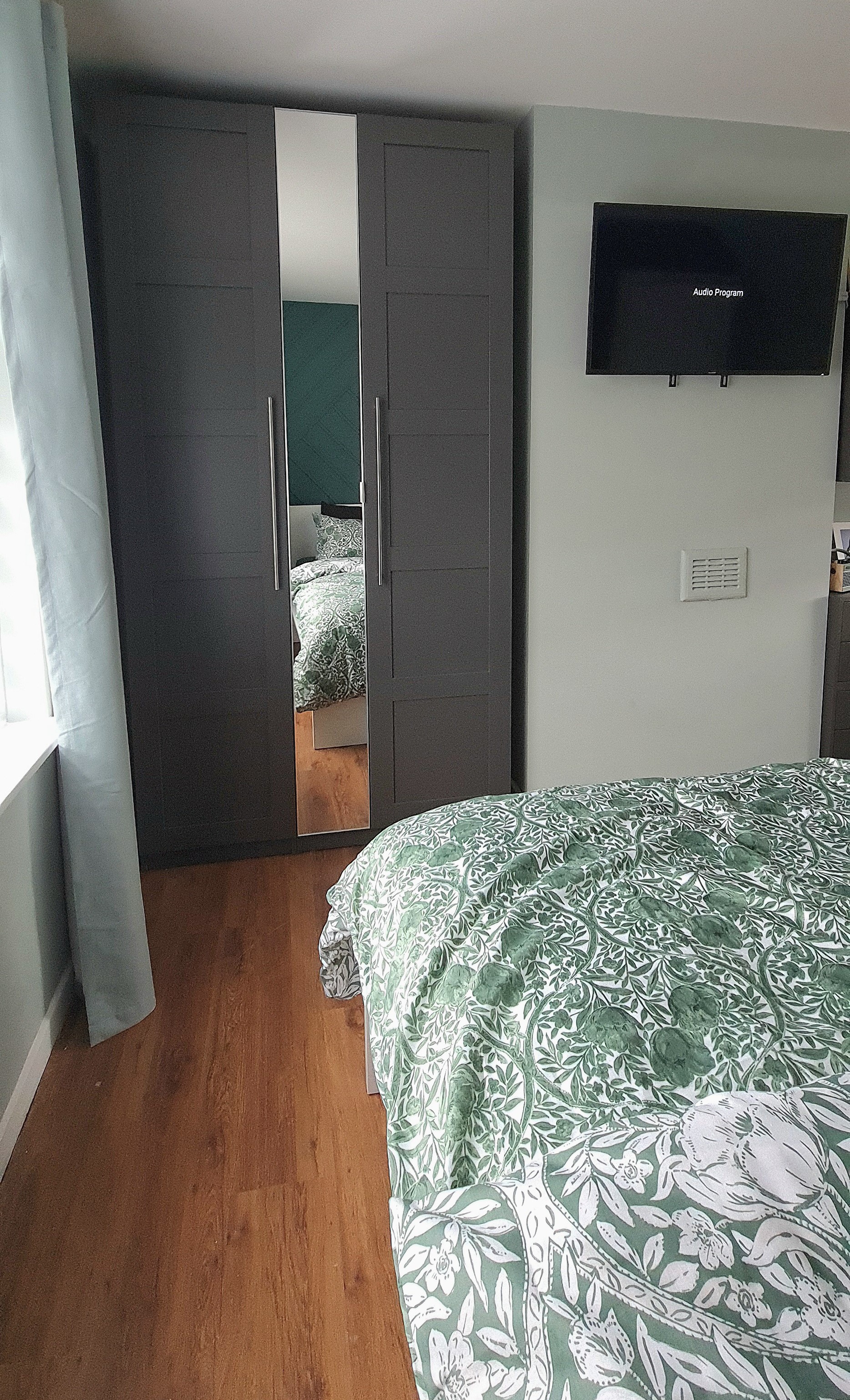 This wardrobe is customised to achieve the most efficient way of using the space with the maximum capacity for storage. We chose the tall and shallow version of the wardrobe frame for a smooth transition to the chimney chest wall, as a normal depth of 60 cm would have stuck out to far. The interiors are adjusted to the needs of the client with a mix of shelves, drawers, and a rail for hangers.