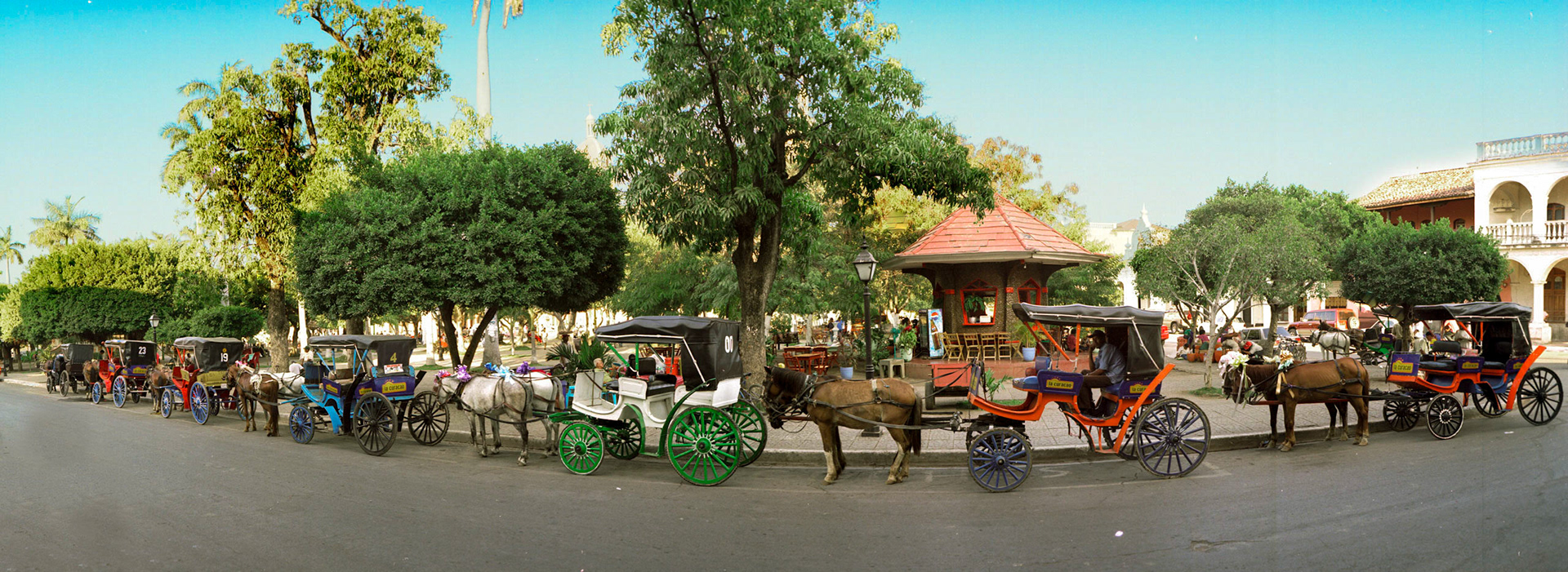 Horse drawn taxis in front of the Central Park in Granada, Nicarauga.