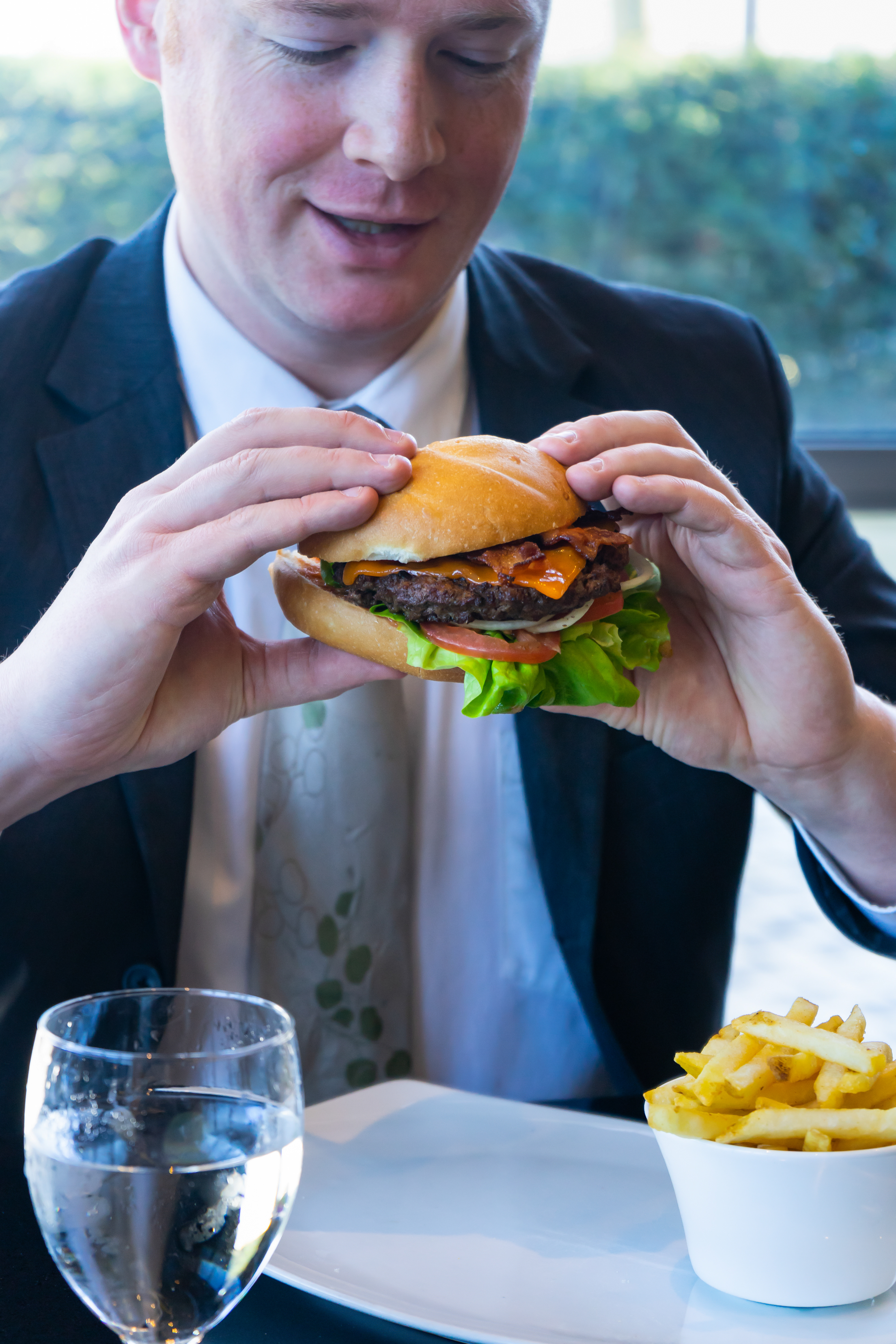 Person Eating Wall Centre Burger At the apron