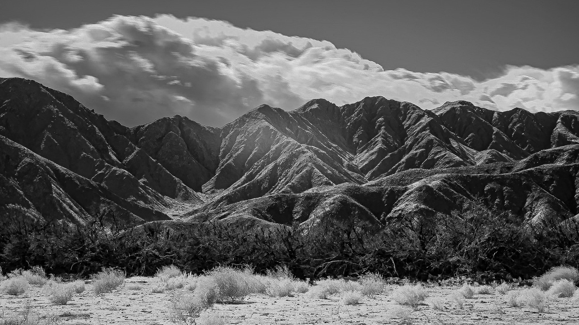A weather system pushes clouds up the San Ysidro Mountains portending rain for a parched Anza-Borrego Desert.