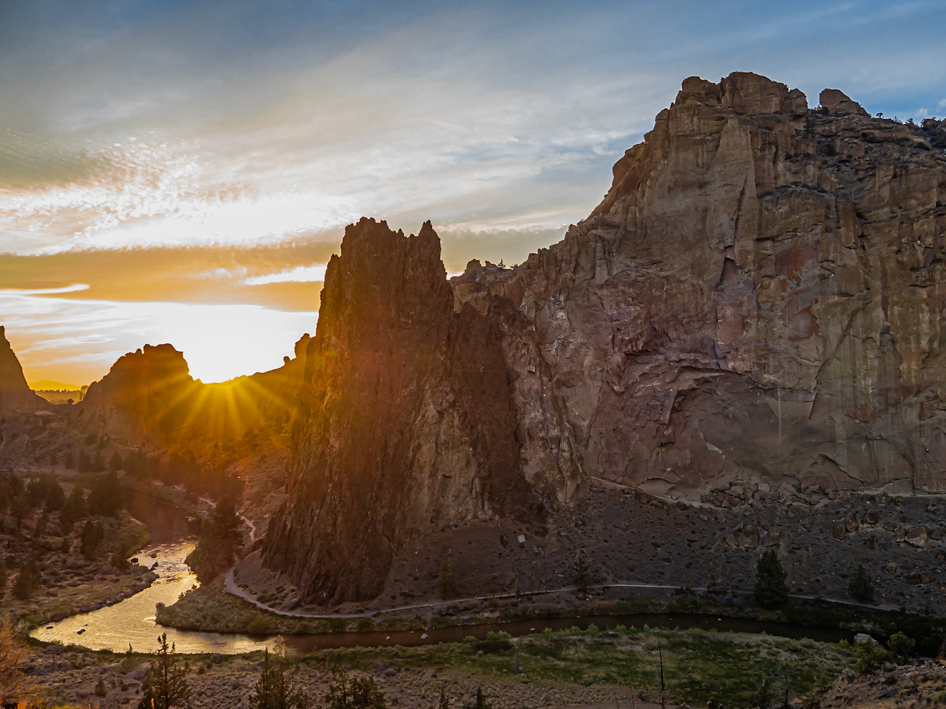 Sunset at Smith Rock: Sunset warms the face of Smith Rock and the Crooked River as it winds around the mountain.