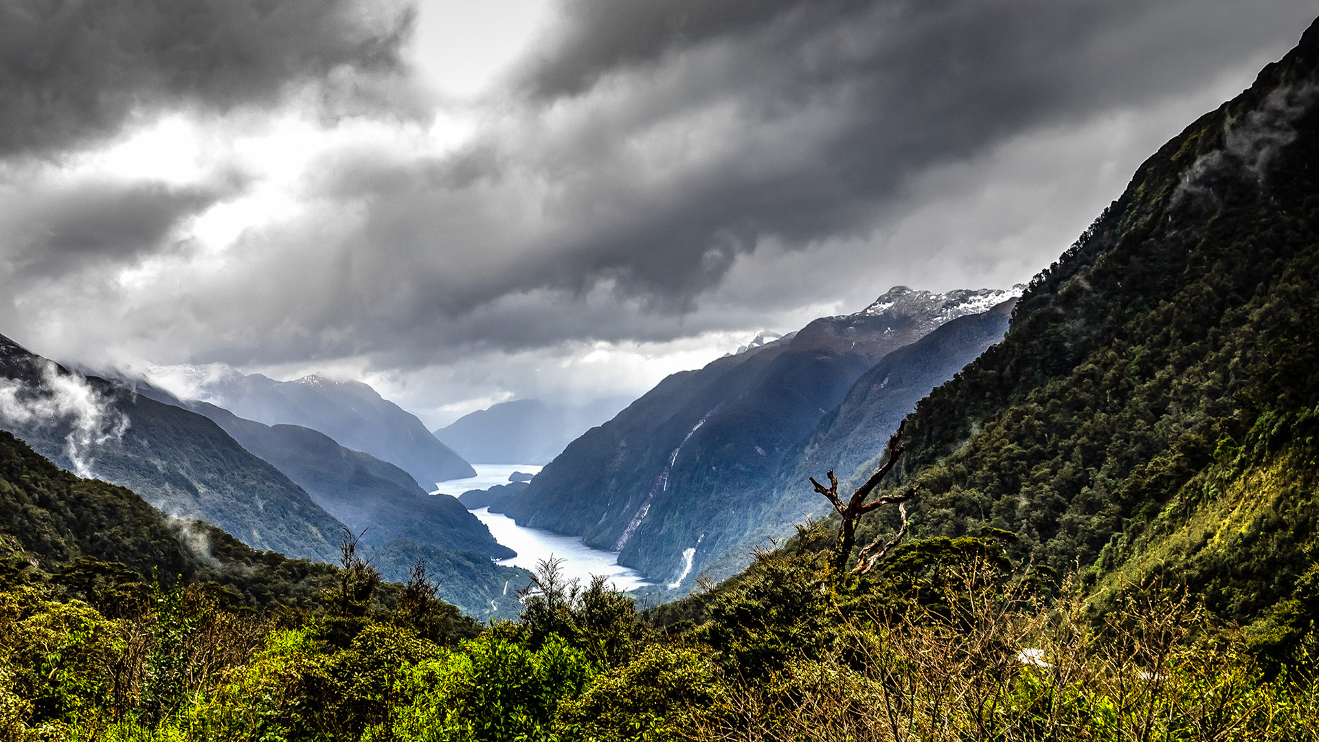Rakituma - the Threatening Sky - Over Doubtful Sound NZ: Doubtful Sound on a stormy day,  flanked by snow-capped peaks and rain-driven cascades.  Viewed from the Wilmot Pass Road.